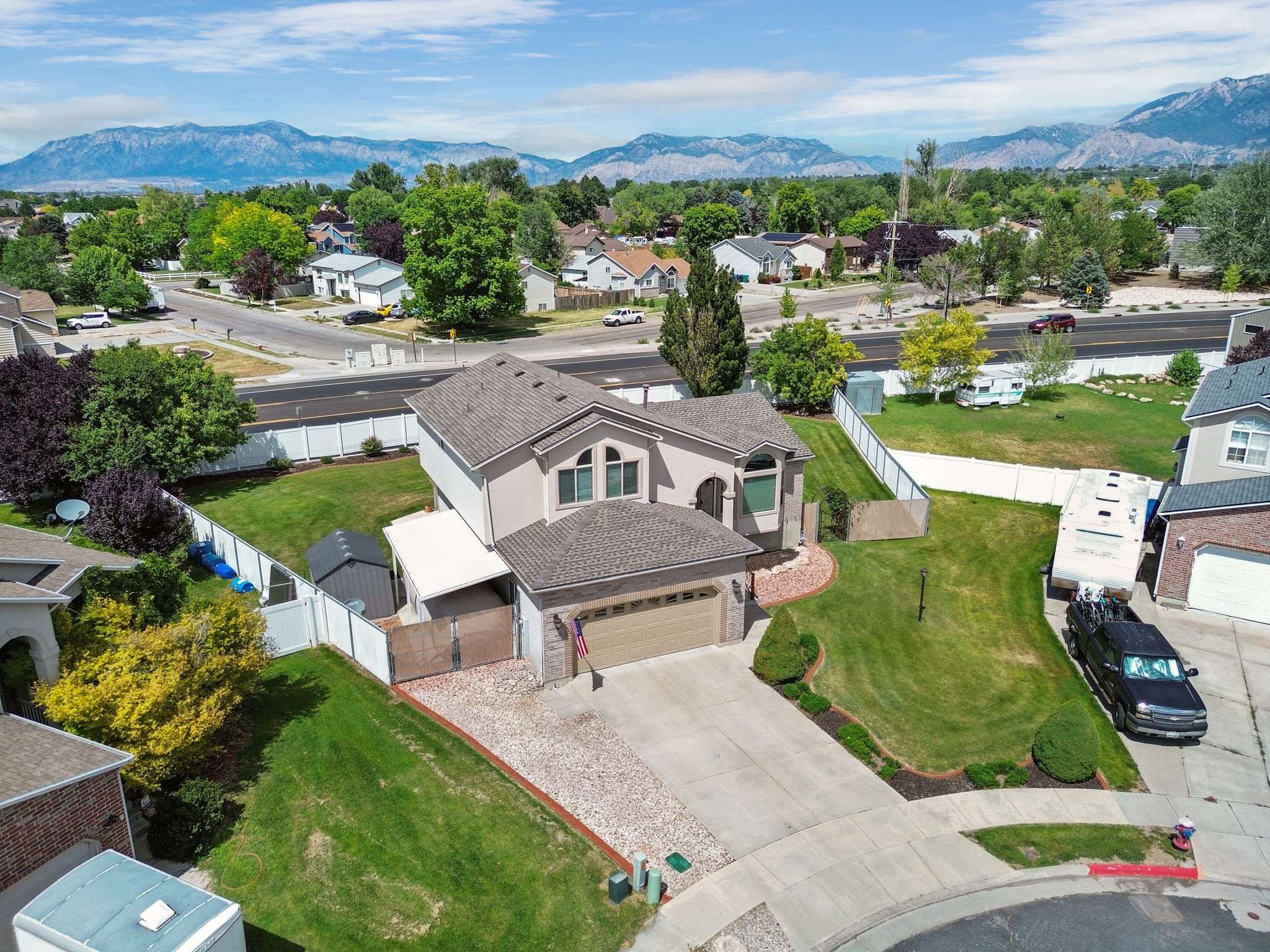 Stucco exterior residence with a two-car garage and a paved driveway