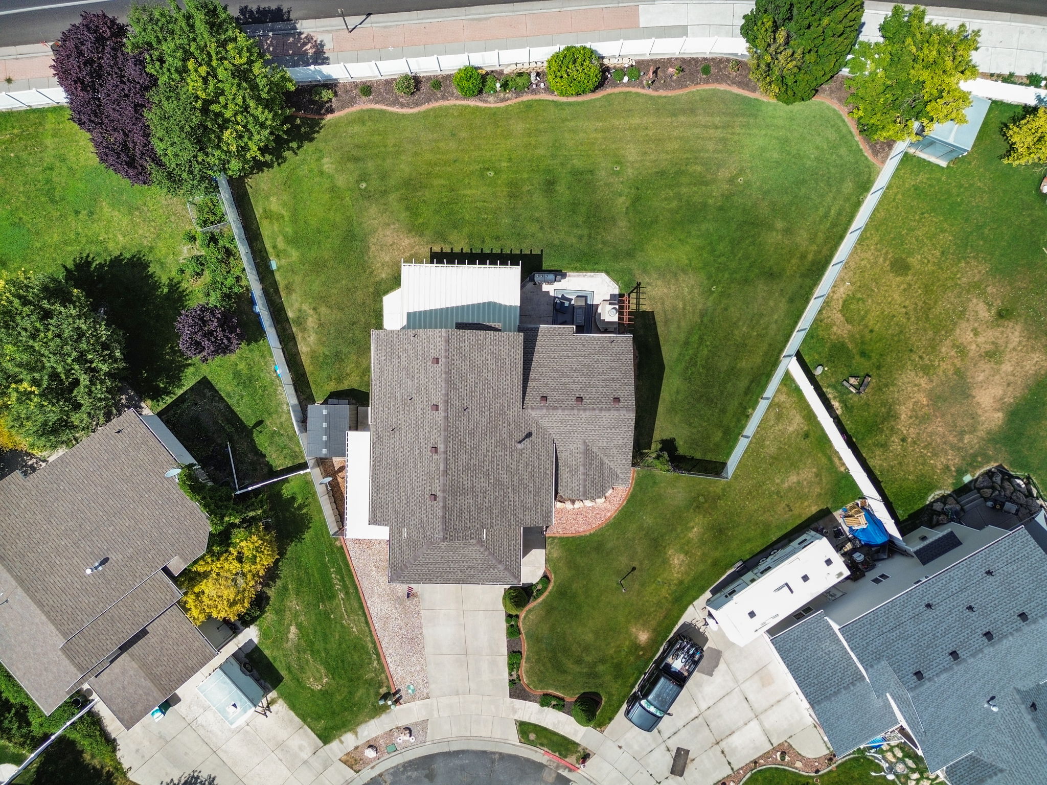 Aerial perspective showcasing a residential property with a multi-gabled roofline