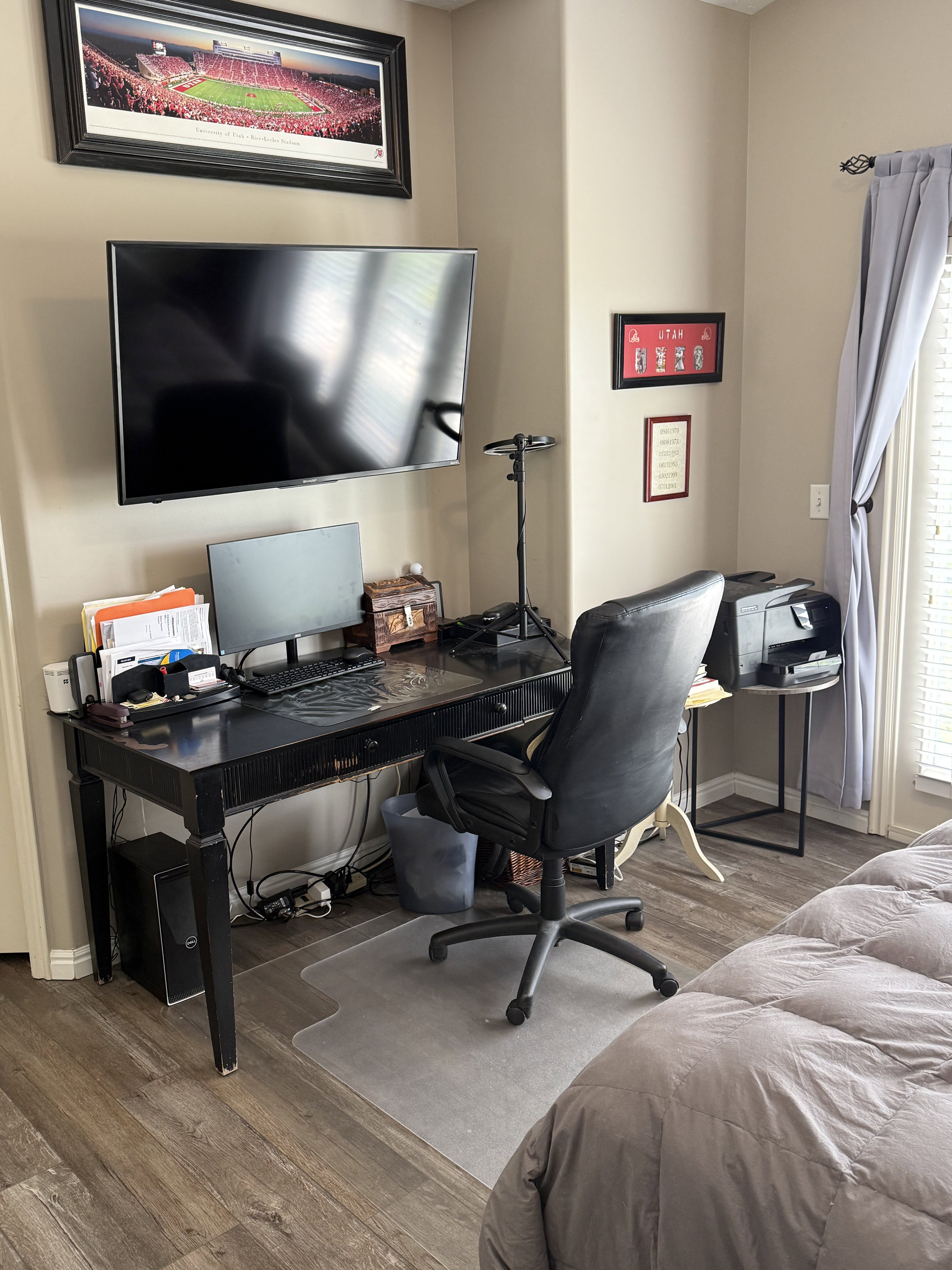 Workstation featuring wood-finish flooring and a wall-mounted television