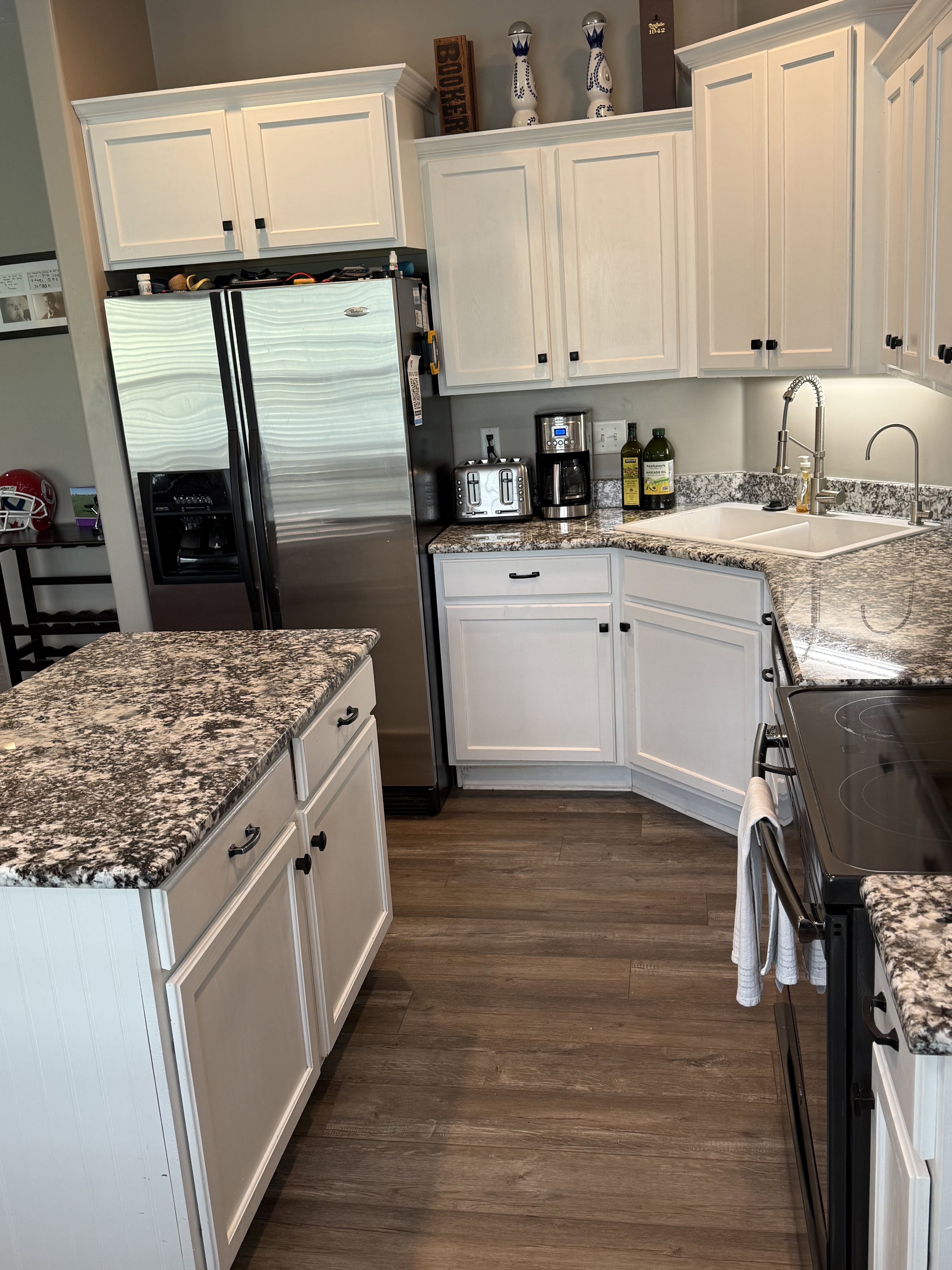 Kitchen featuring white shaker cabinetry, granite countertops, wood-finish flooring, a stainless steel side-by-side refrigerator, and an electric range