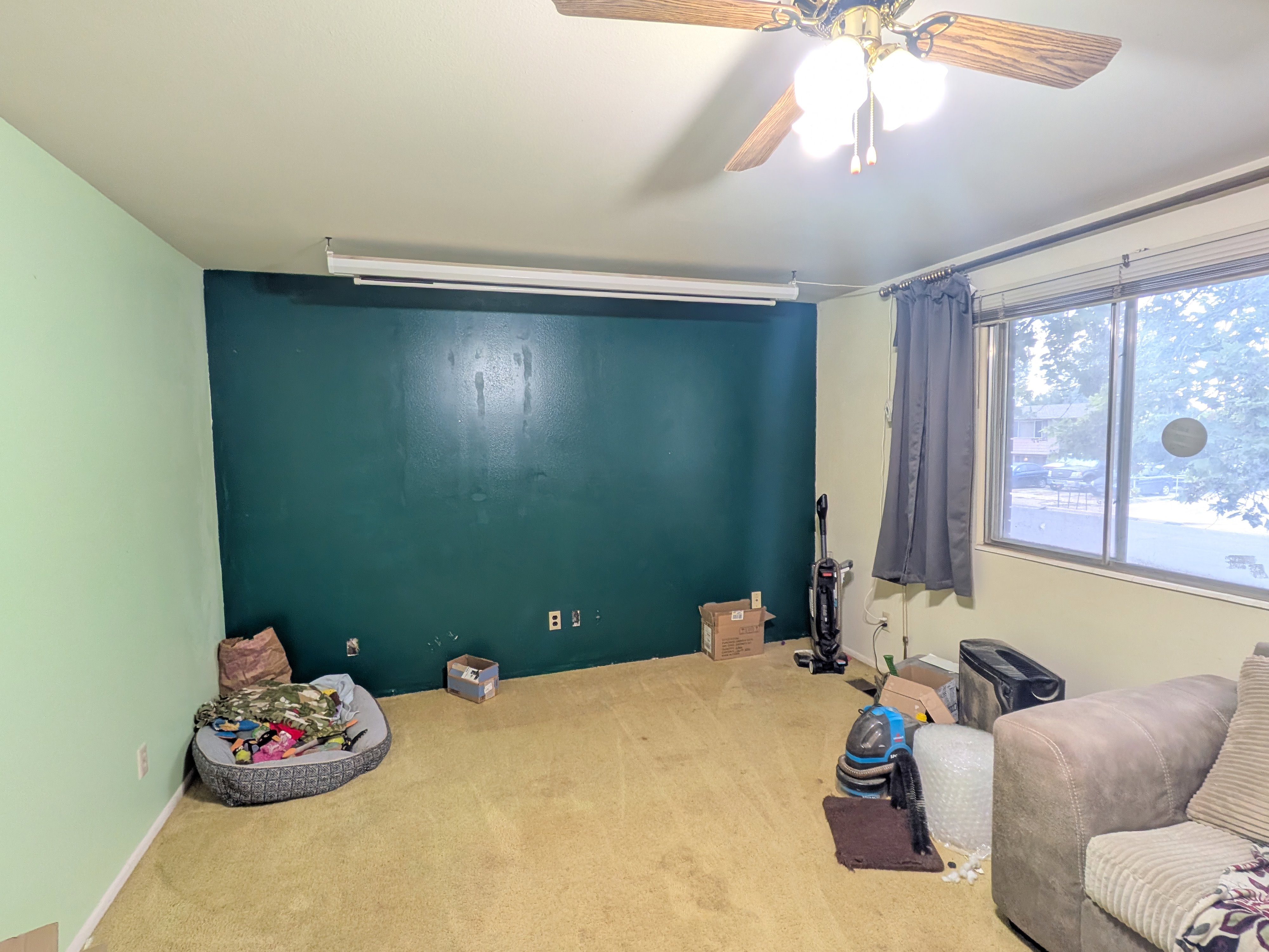 Room featuring a ceiling fan with light fixture, wall-to-wall carpeting, and a window with blinds