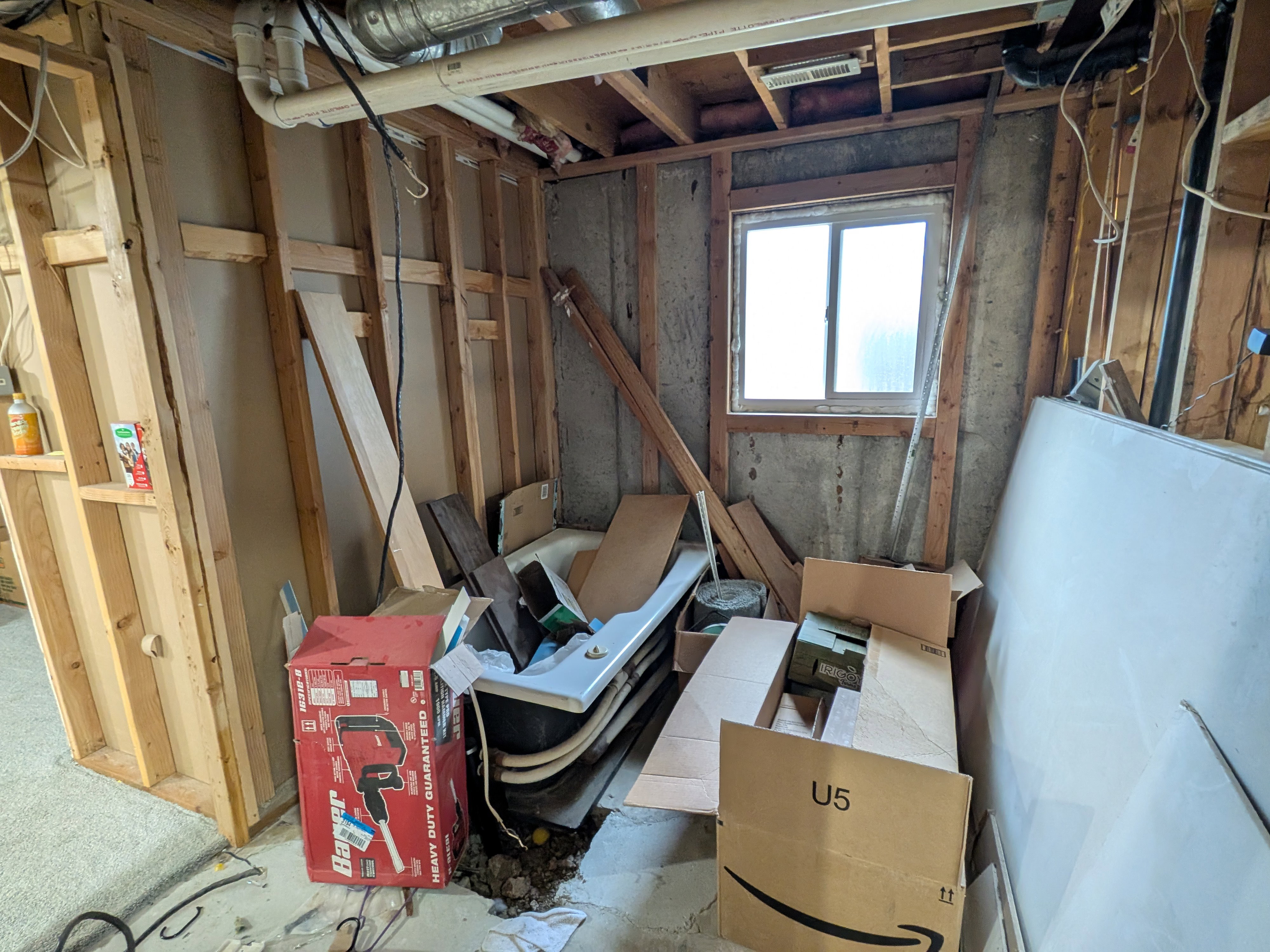 Tub, drywall and tile in bathroom ready to be finished