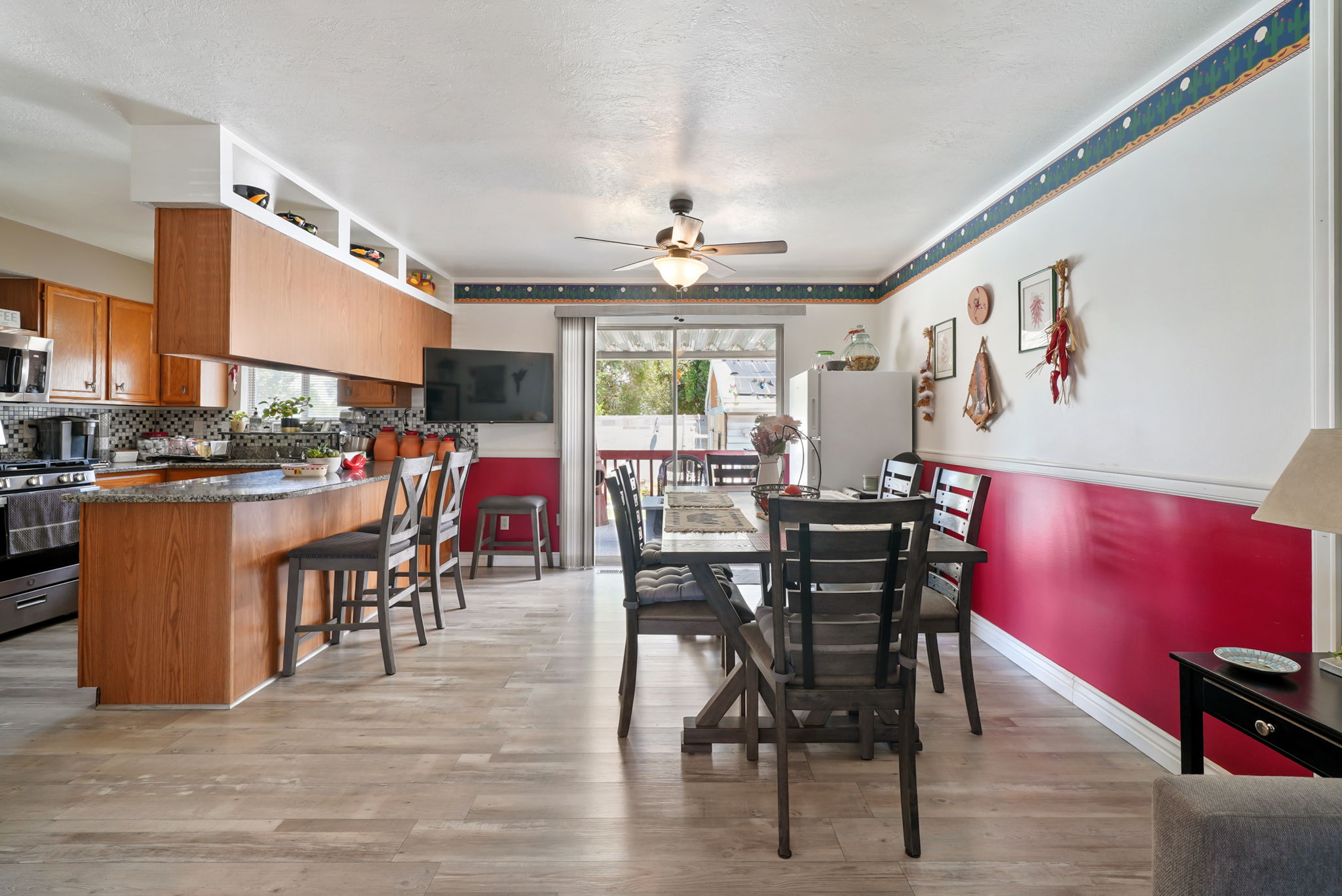 Open-concept kitchen and dining area featuring wood-finish flooring