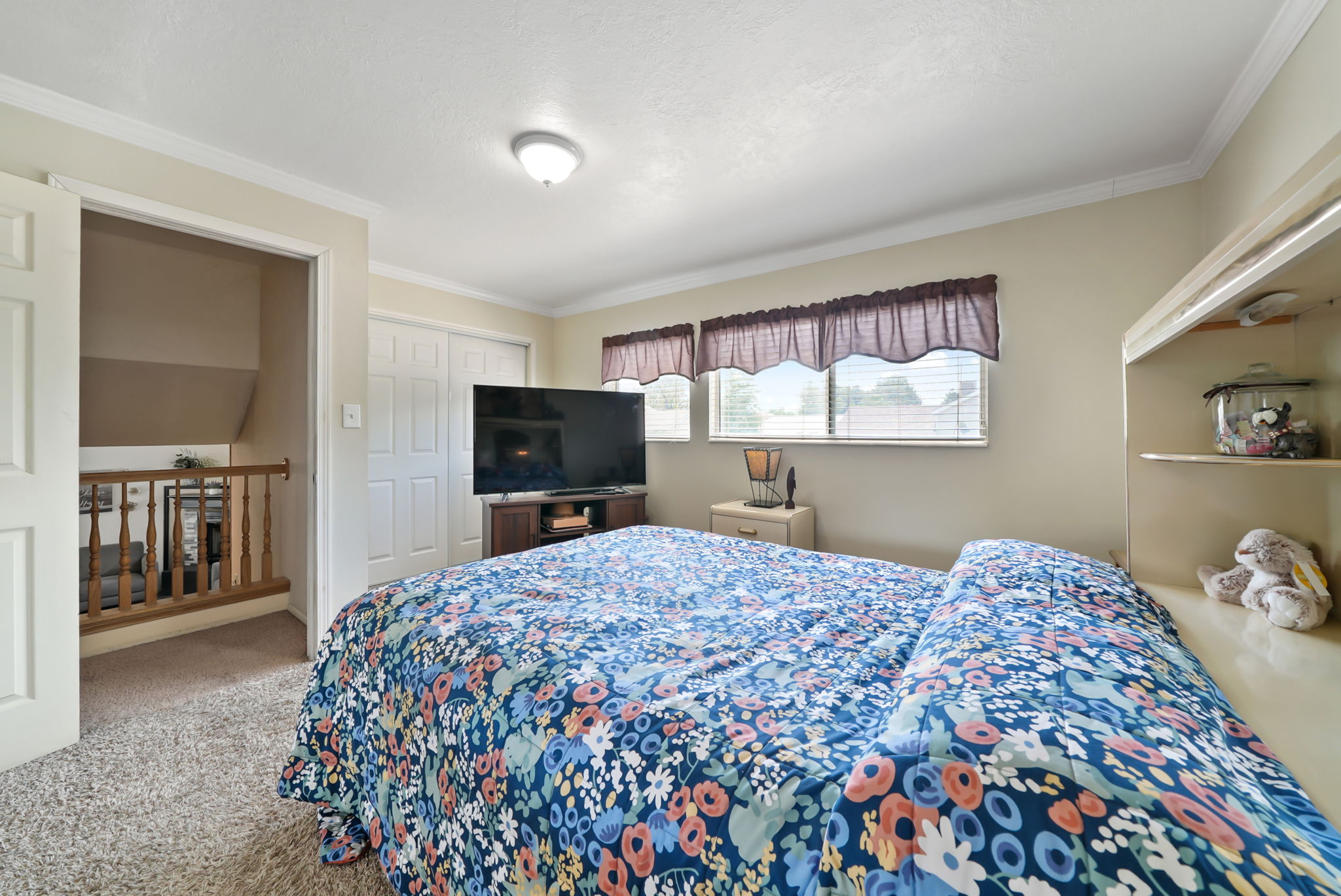 Carpeted room with neutral wall tones and white trim