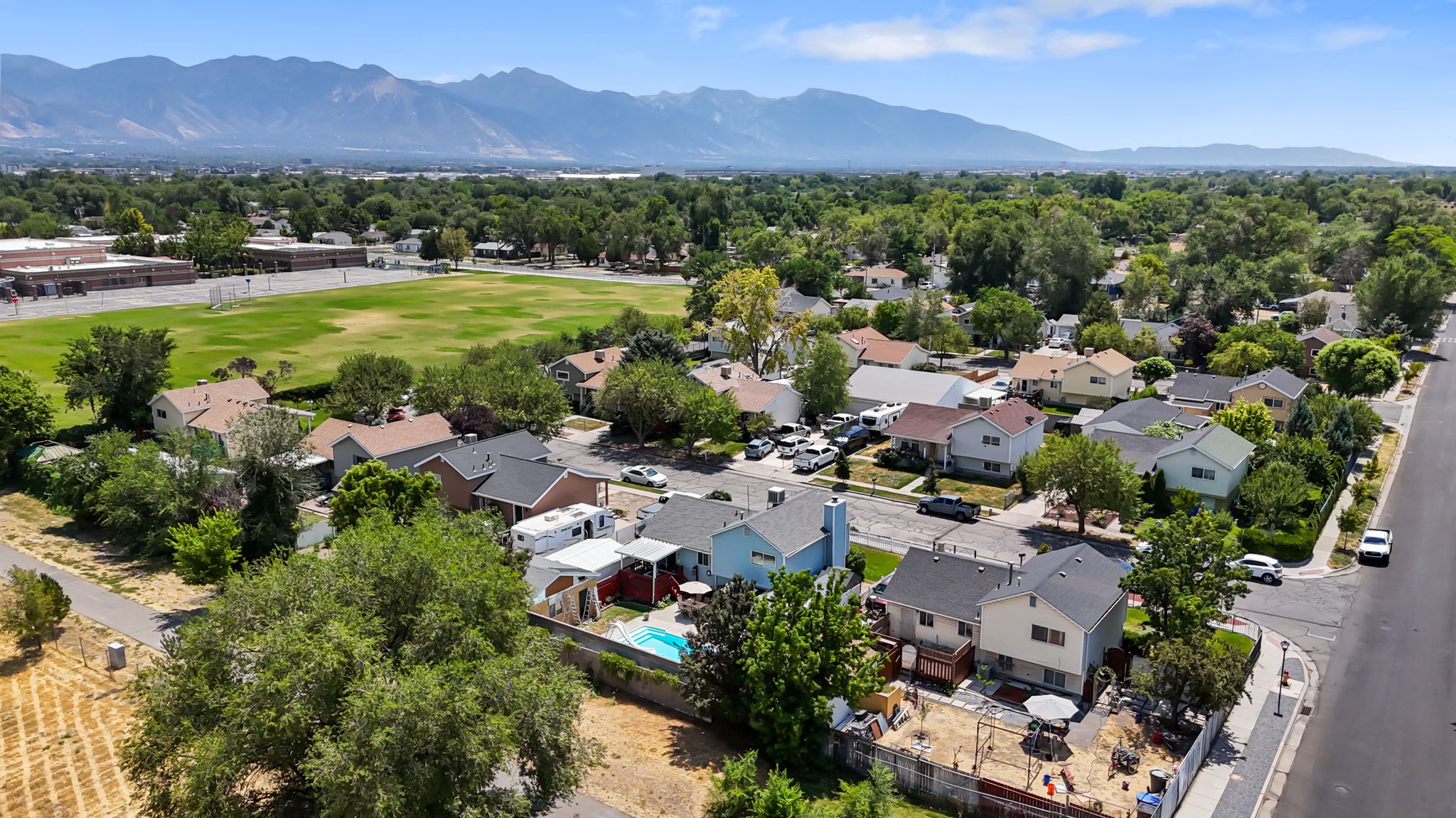 Aerial view showcasing the residential neighborhood with a distant mountainous backdrop