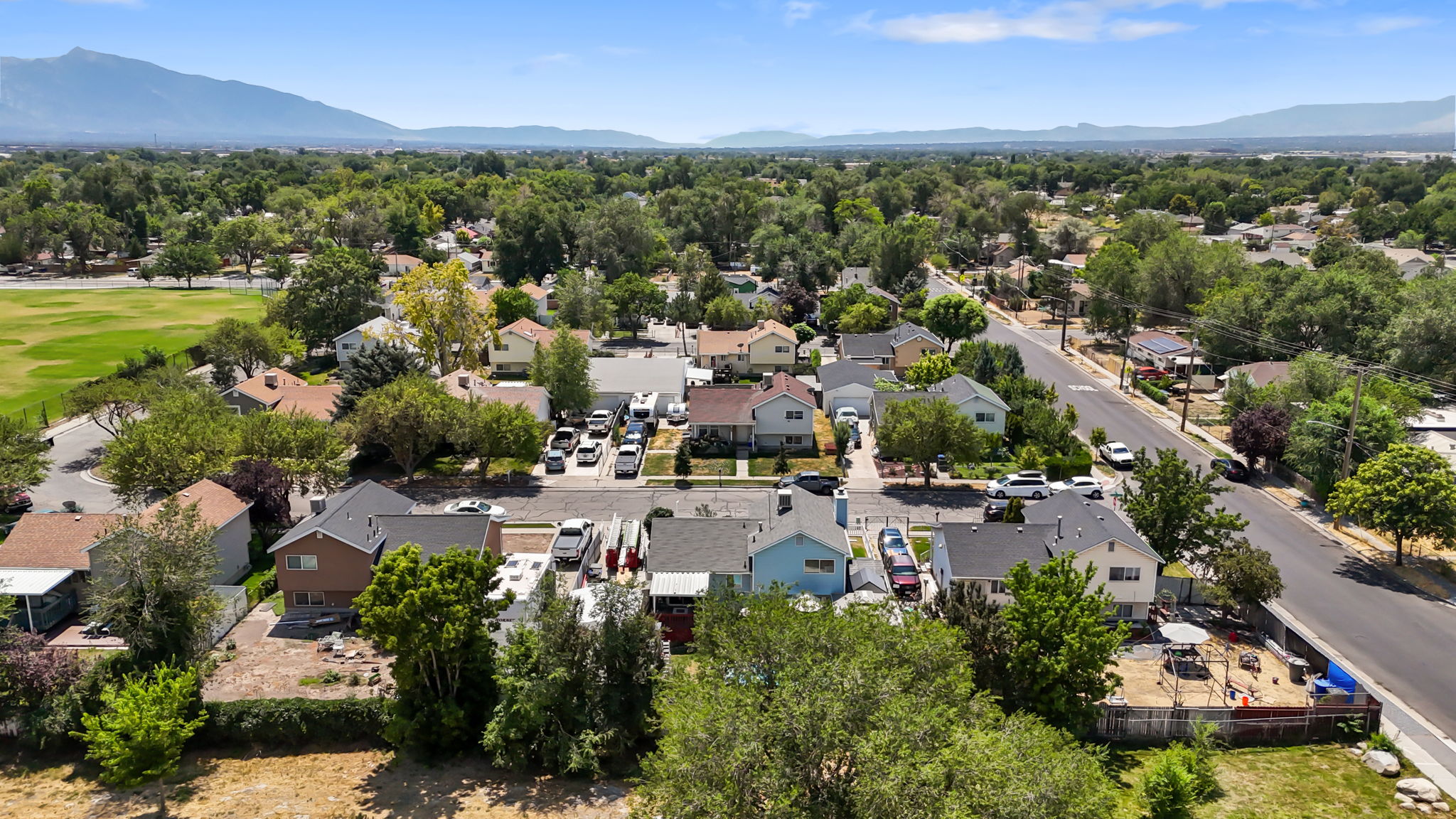 Aerial view showcasing a residential neighborhood with a distant mountain backdrop