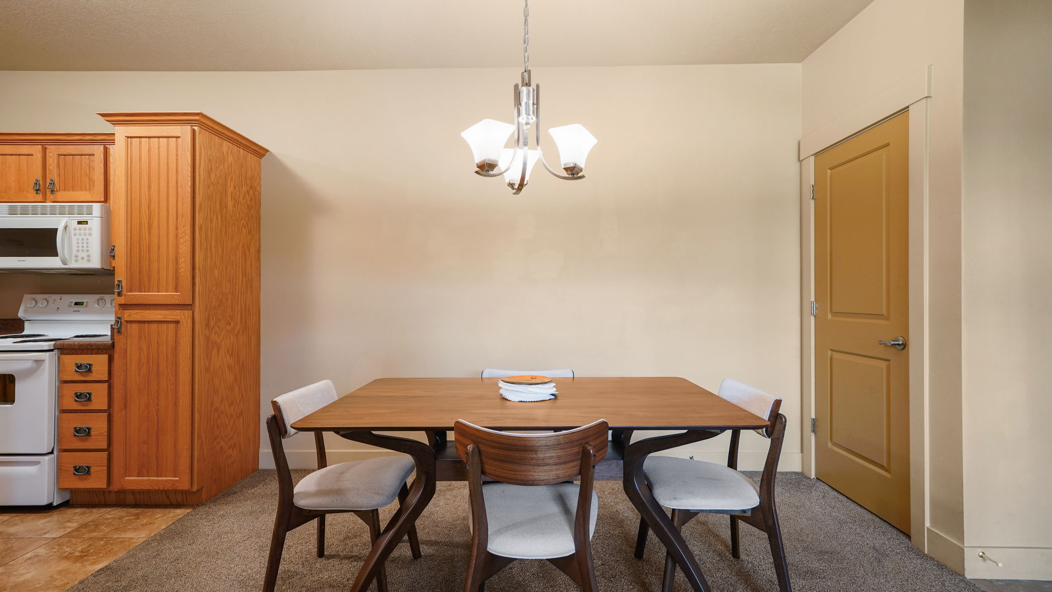 Dining area featuring a contemporary chandelier and neutral wall tones