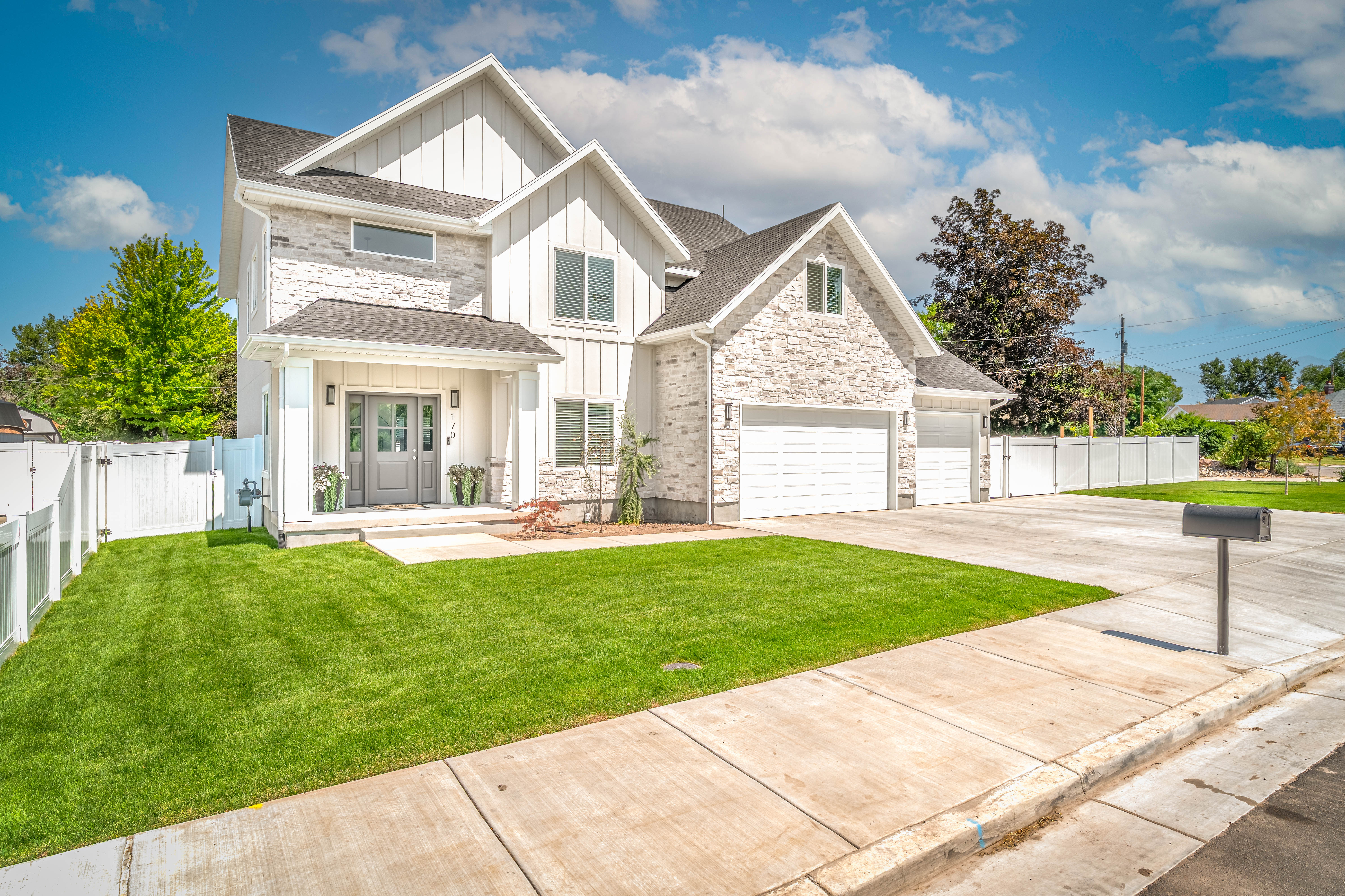 Modern farmhouse architecture featuring board and batten siding and stone veneer accents