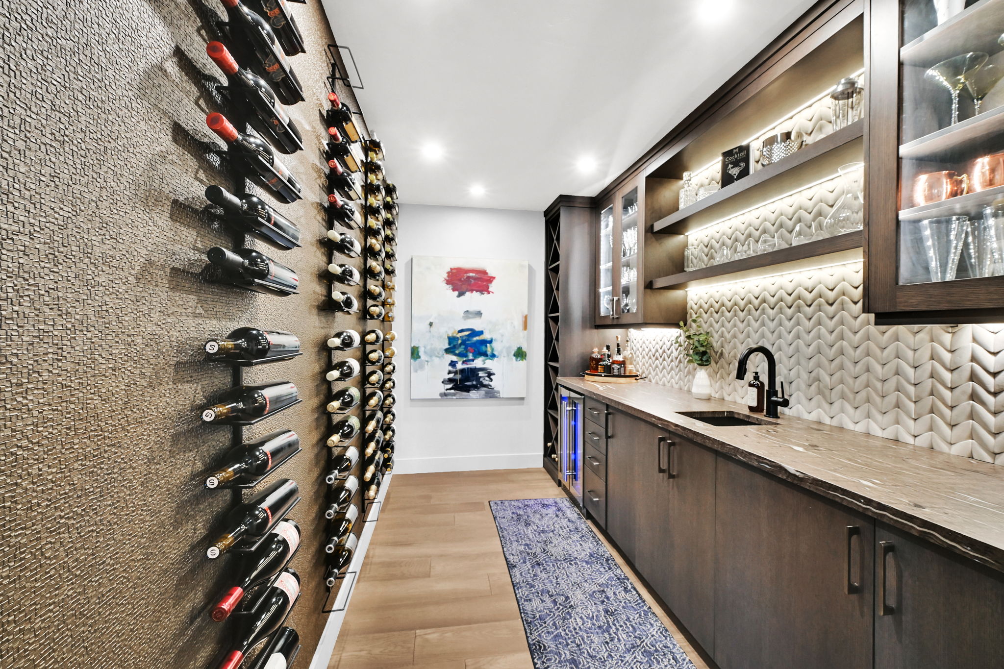 Dedicated beverage preparation area featuring dark wood-finish cabinetry, a stone countertop, and a matte black faucet
