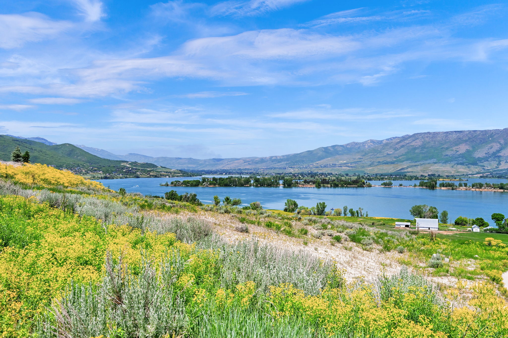 Expansive water frontage with mountain backdrop
