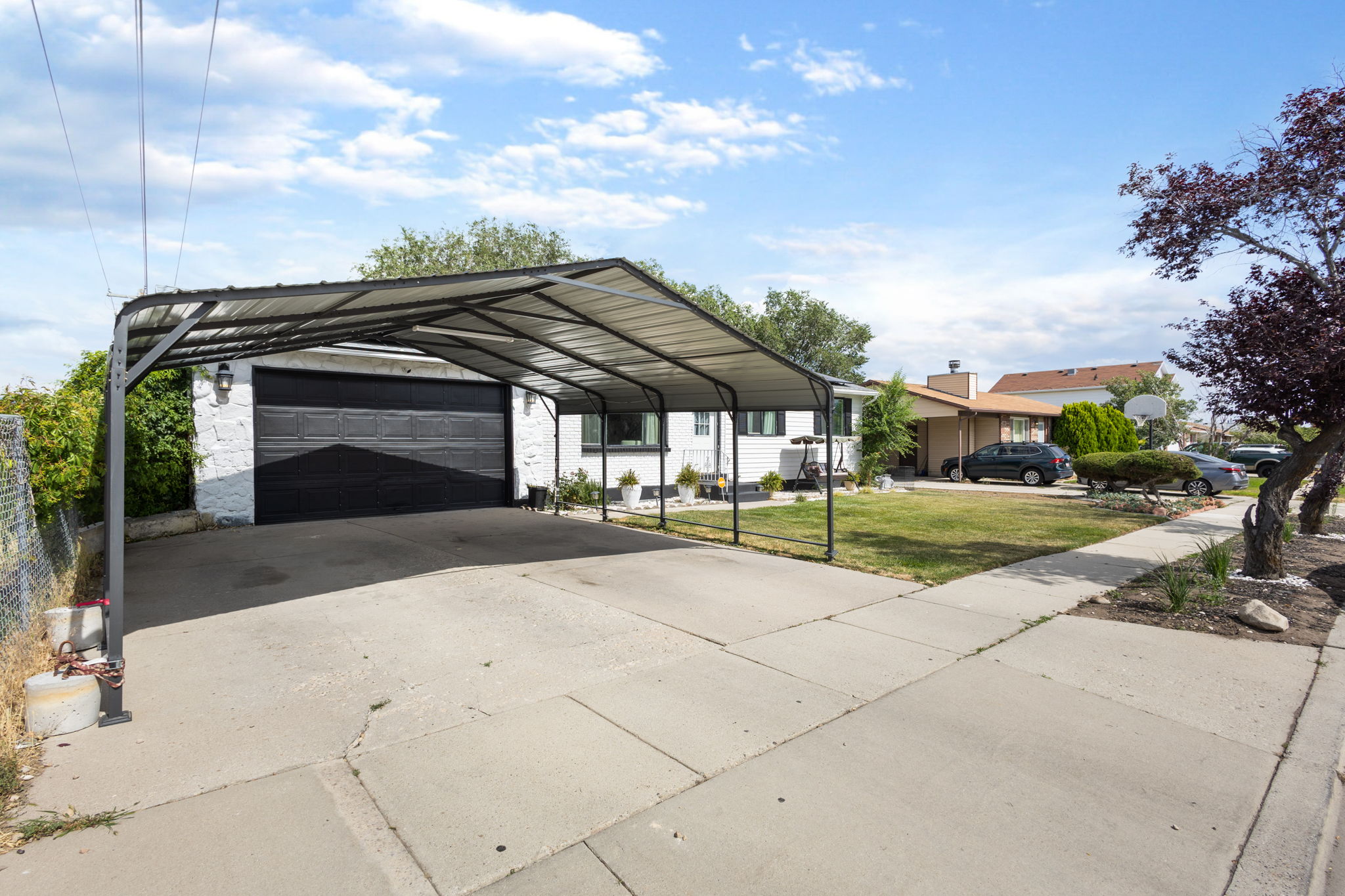 Driveway with an attached carport, offering covered parking