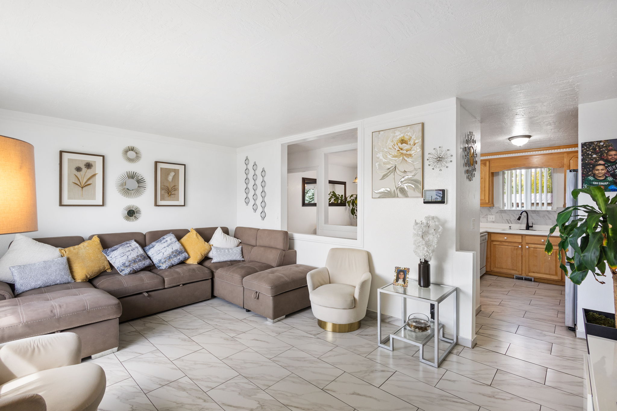 Bright living area featuring light-toned tile flooring