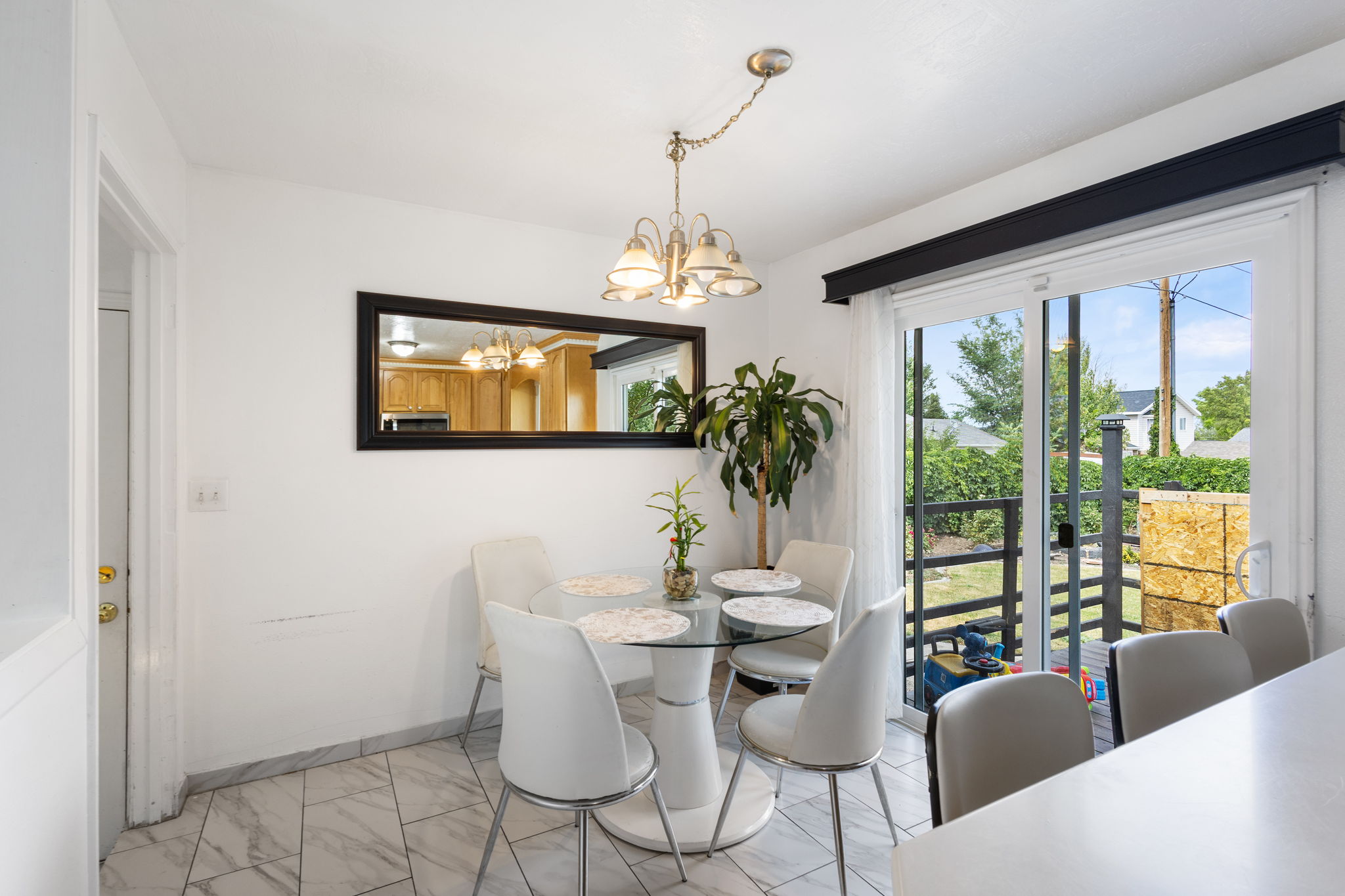 Dining area with white walls and patterned tile flooring