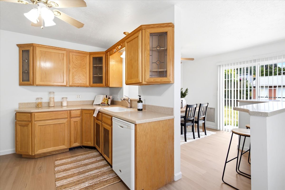 Kitchen featuring light wood cabinetry, light-toned countertops, and wood-finish flooring