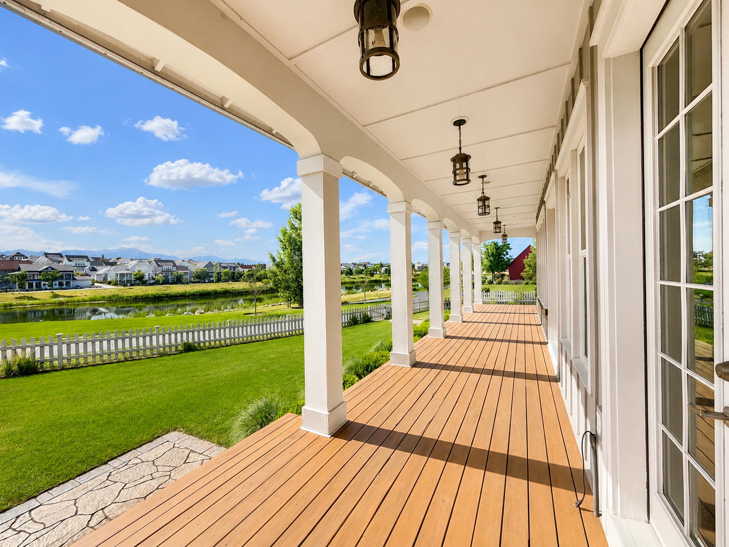 Covered porch featuring multiple hanging lantern-style fixtures