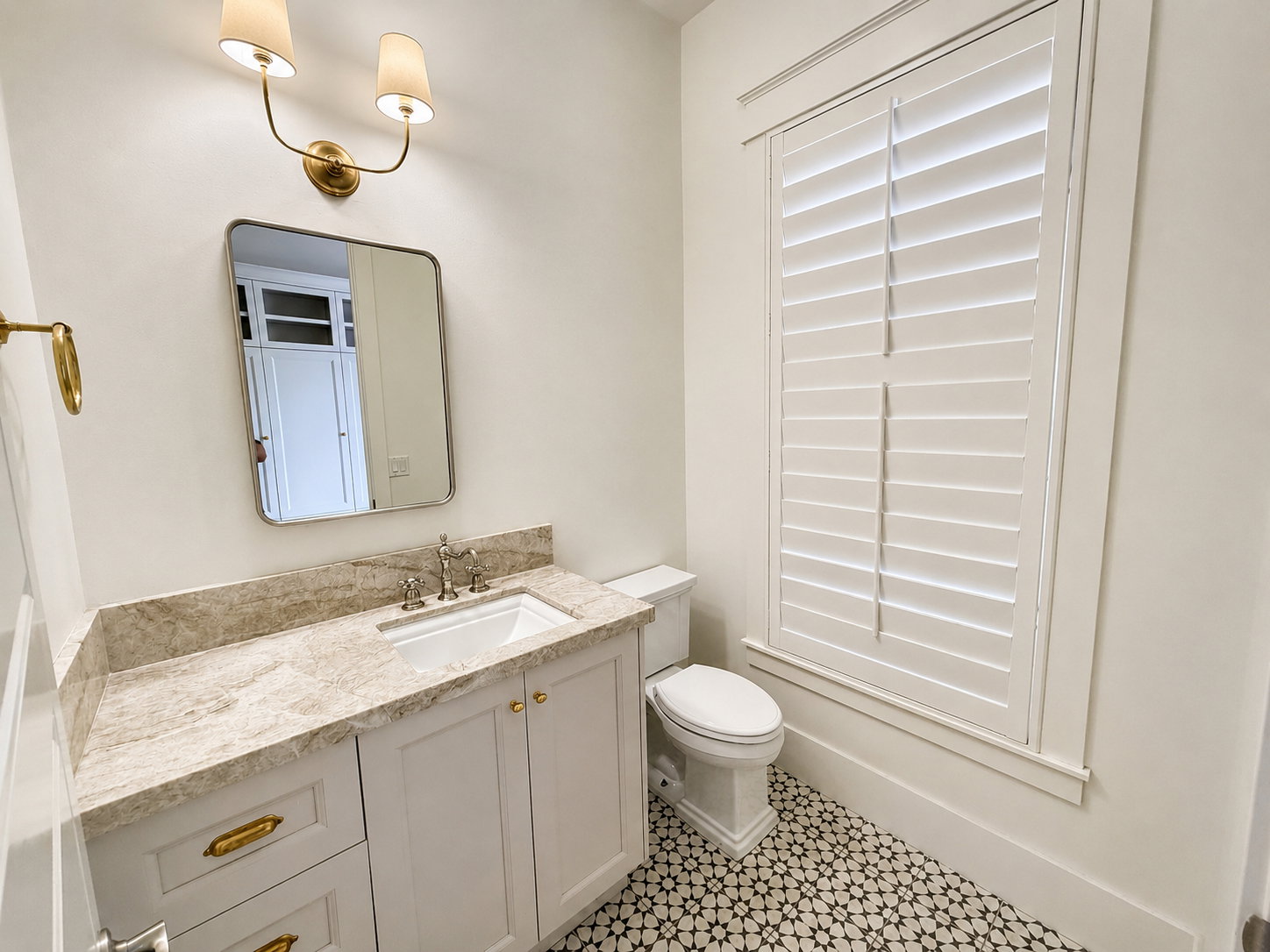First floor powder bath with Taj Mahal quartzite counter