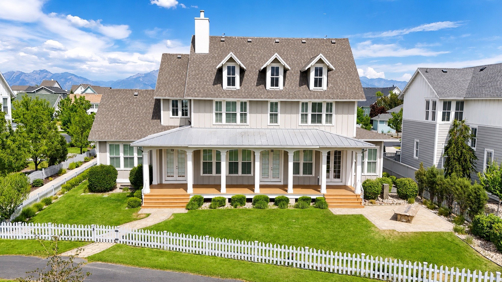 The two-story residence features a full length covered view porch and metal roof accent