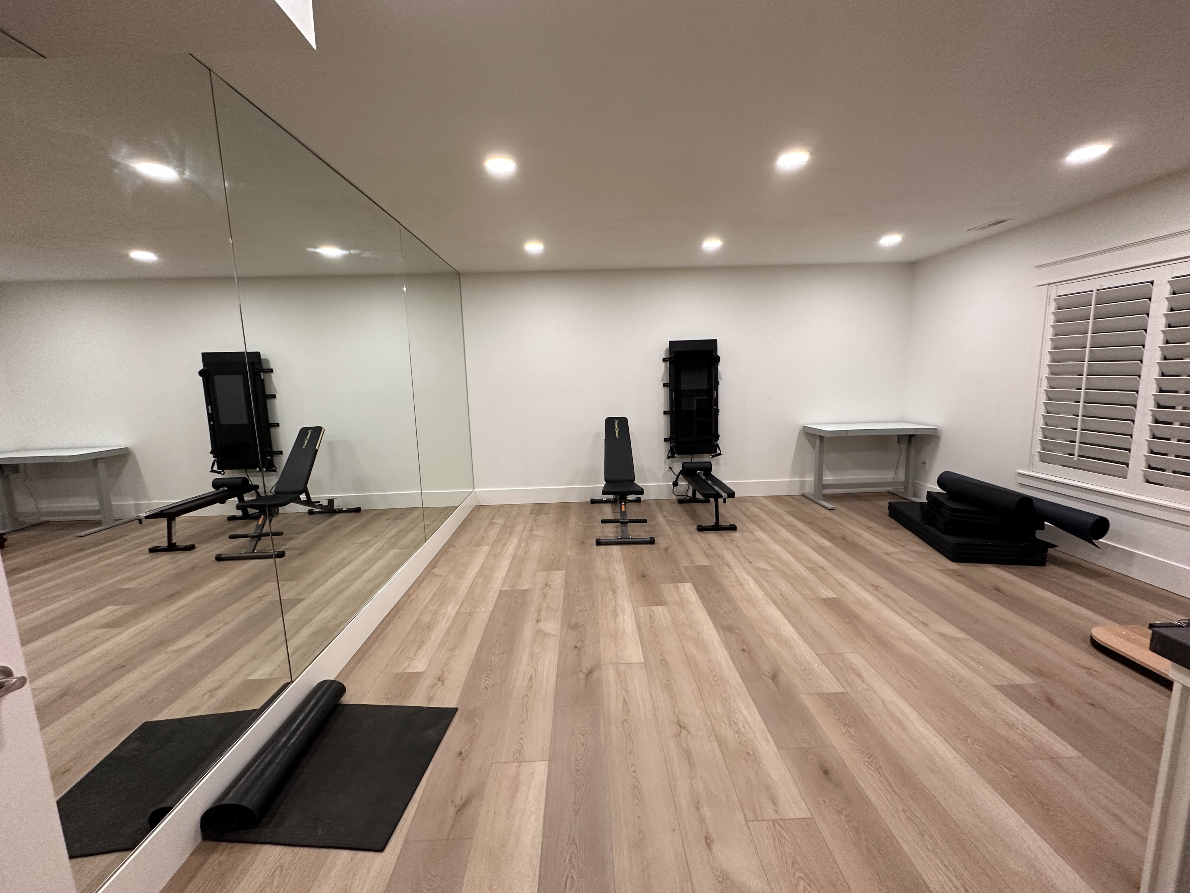 Exercise/Dance room featuring a full wall of mirrors and wood flooring