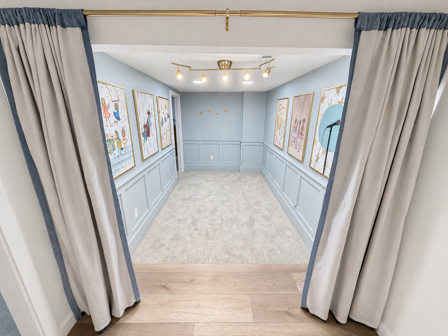 Stage room audience area with custom lighting and wainscoting.