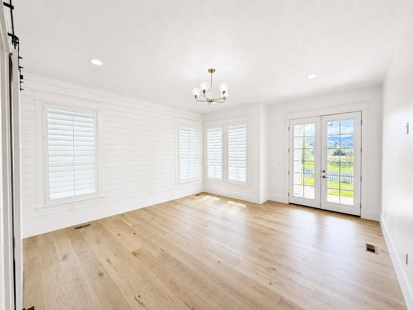 Primary bedroom with covered porch access offering lake and mountain views