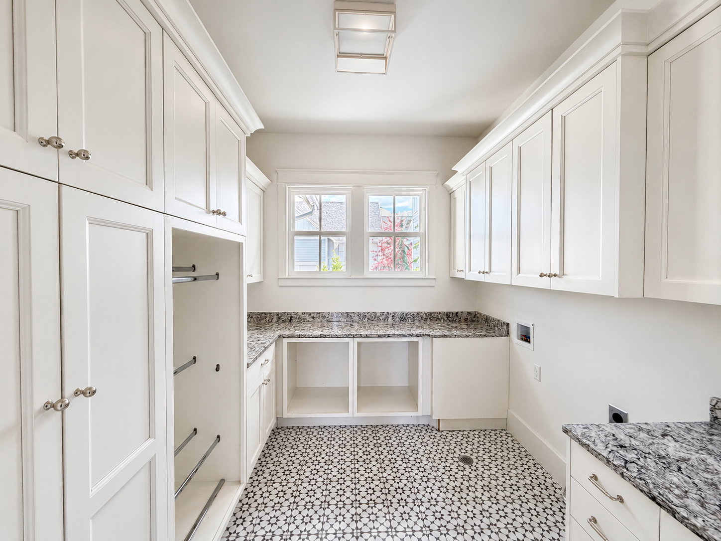 Entry level laundry room with lots of storage and natural light