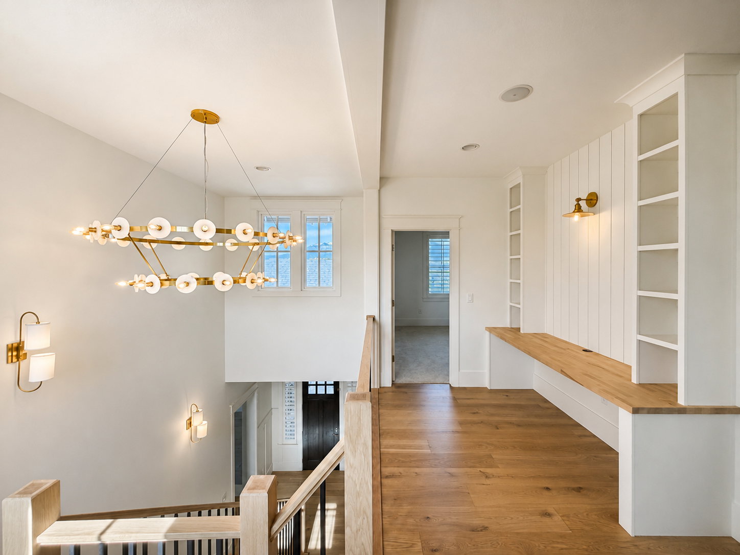 Upper-level landing featuring built-in study area and shelving