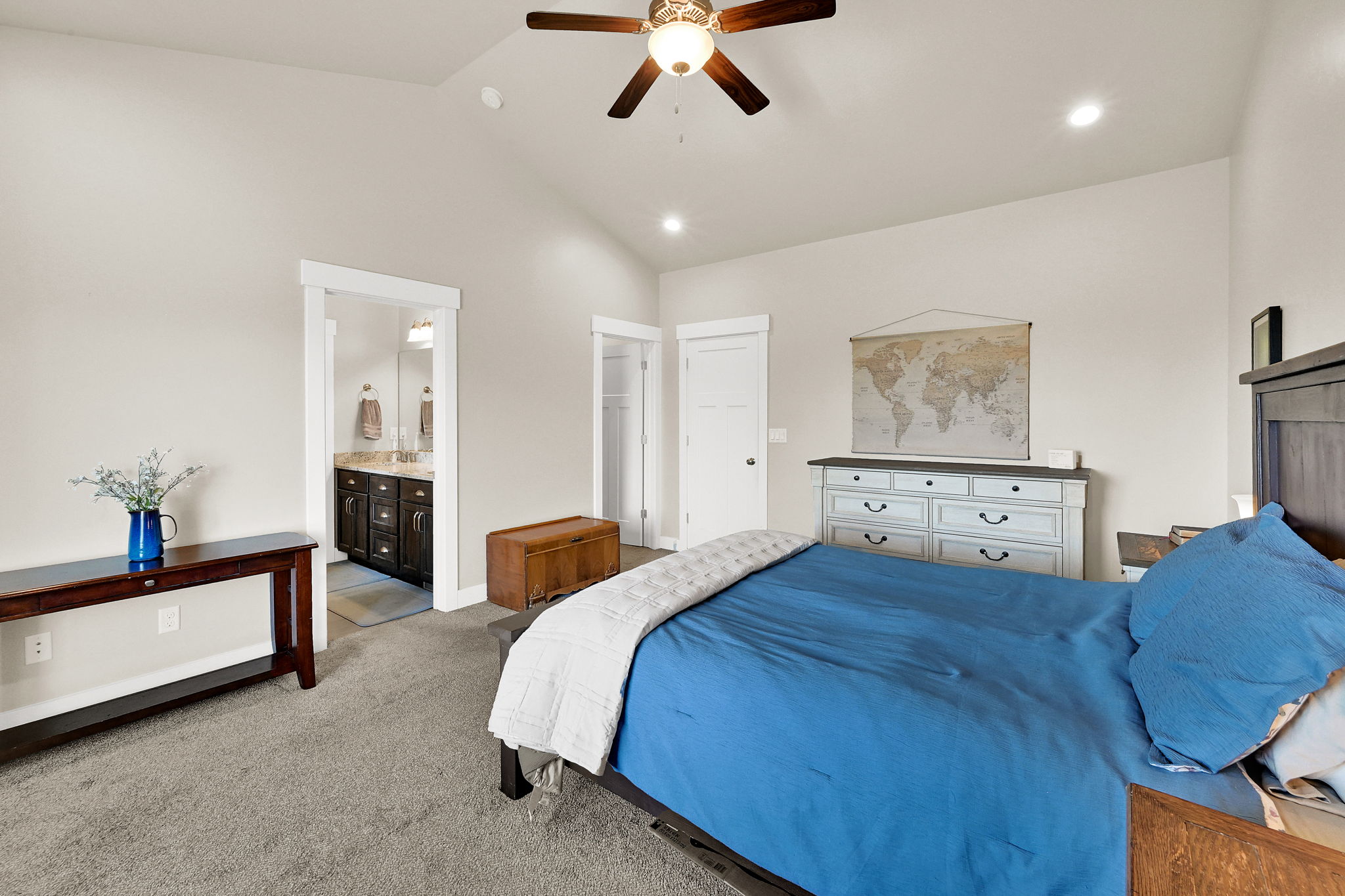 Spacious bedroom with vaulted ceiling, recessed lighting, and a ceiling fan