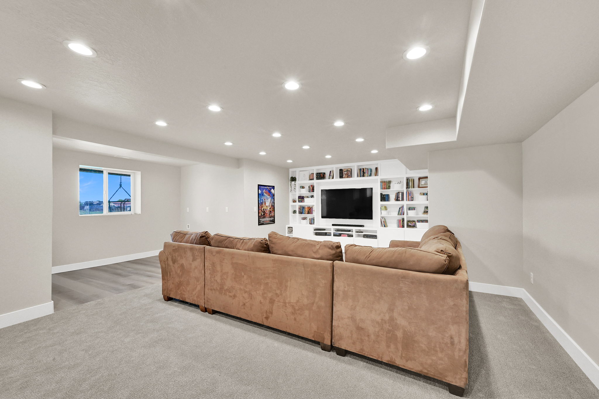 Recreation room featuring recessed lighting, a built-in media center with shelving, and light-tone carpeting