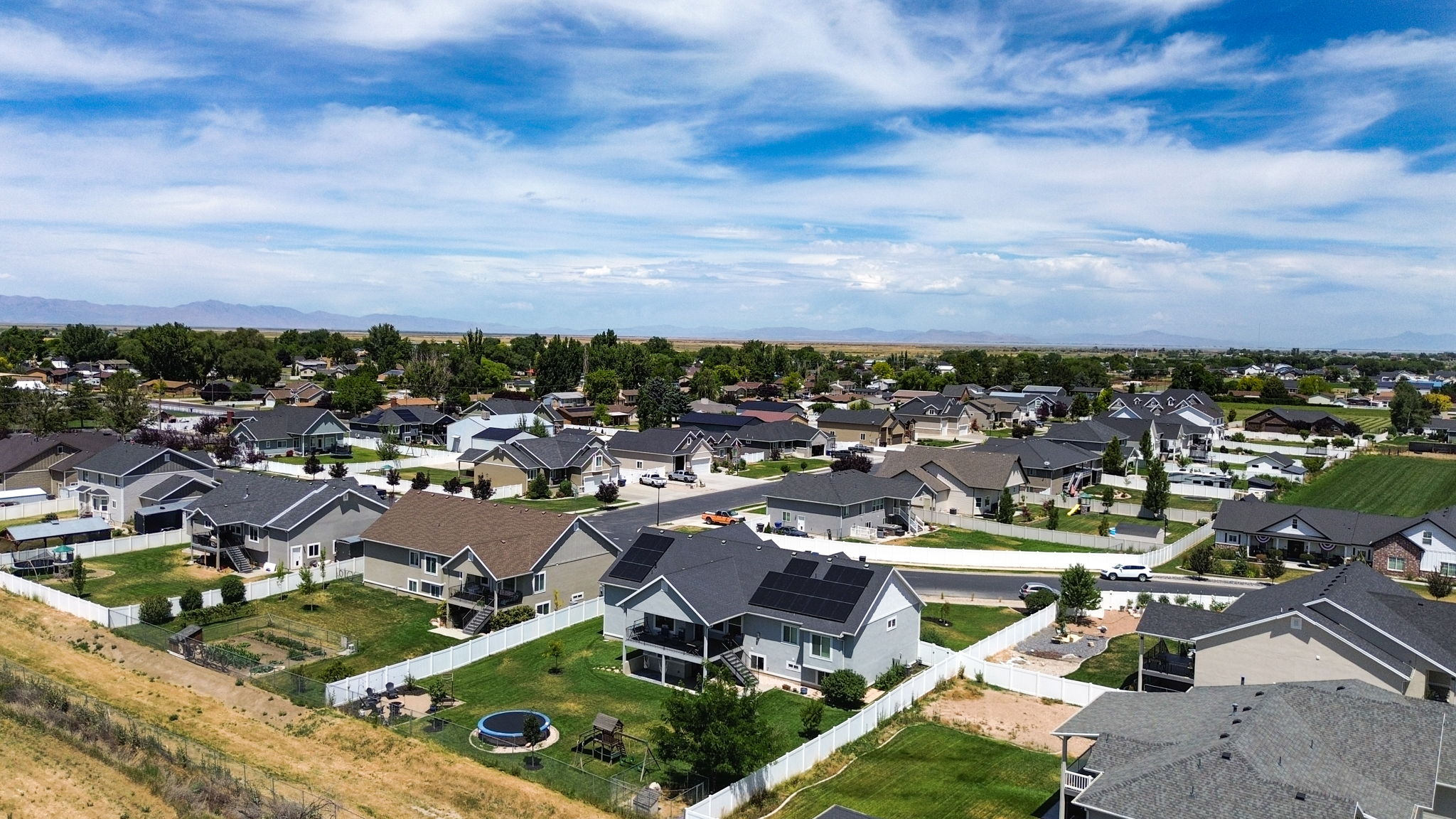 Aerial perspective showcasing an established residential community with a variety of single-family homes, each featuring individual yards
