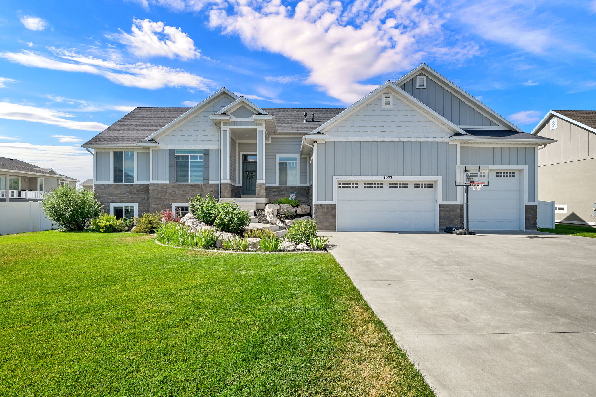Contemporary exterior featuring light blue siding with stone accents