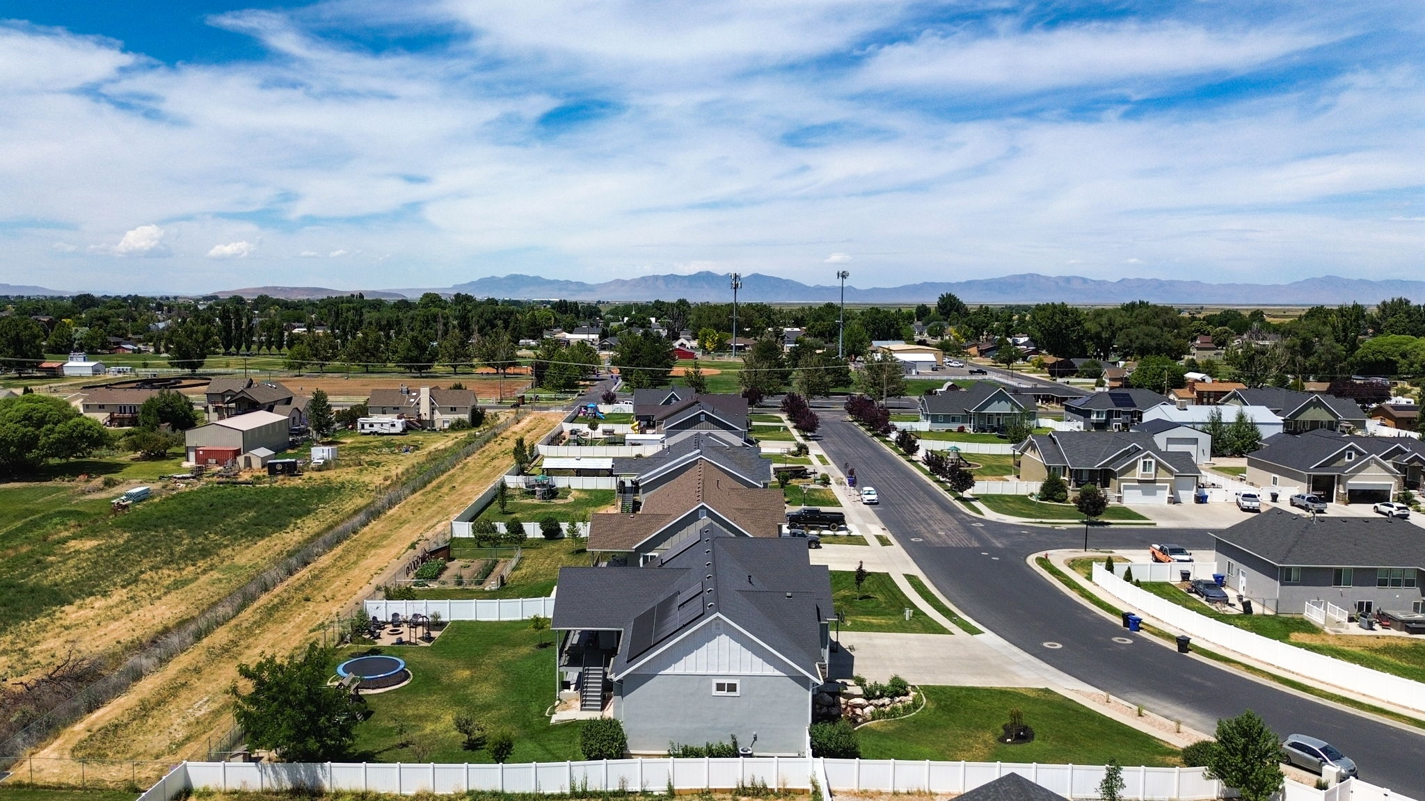 Aerial perspective showcasing a residential neighborhood with mountain backdrops