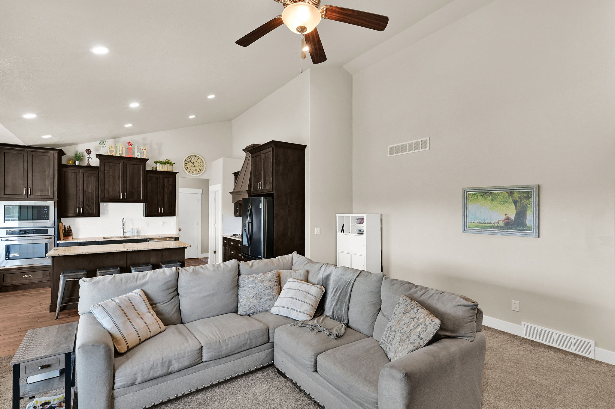 Open-concept living area featuring vaulted ceilings and recessed lighting