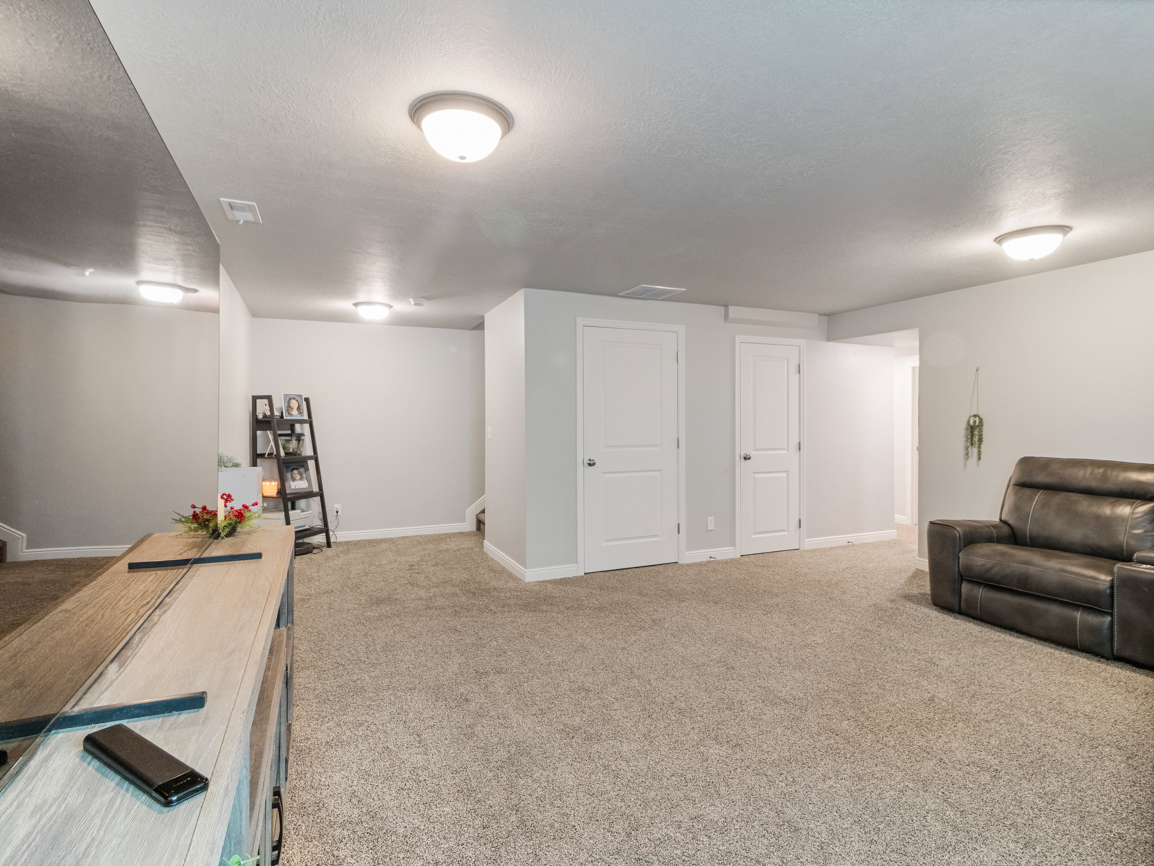 Spacious room featuring neutral carpeting and light gray wall paint