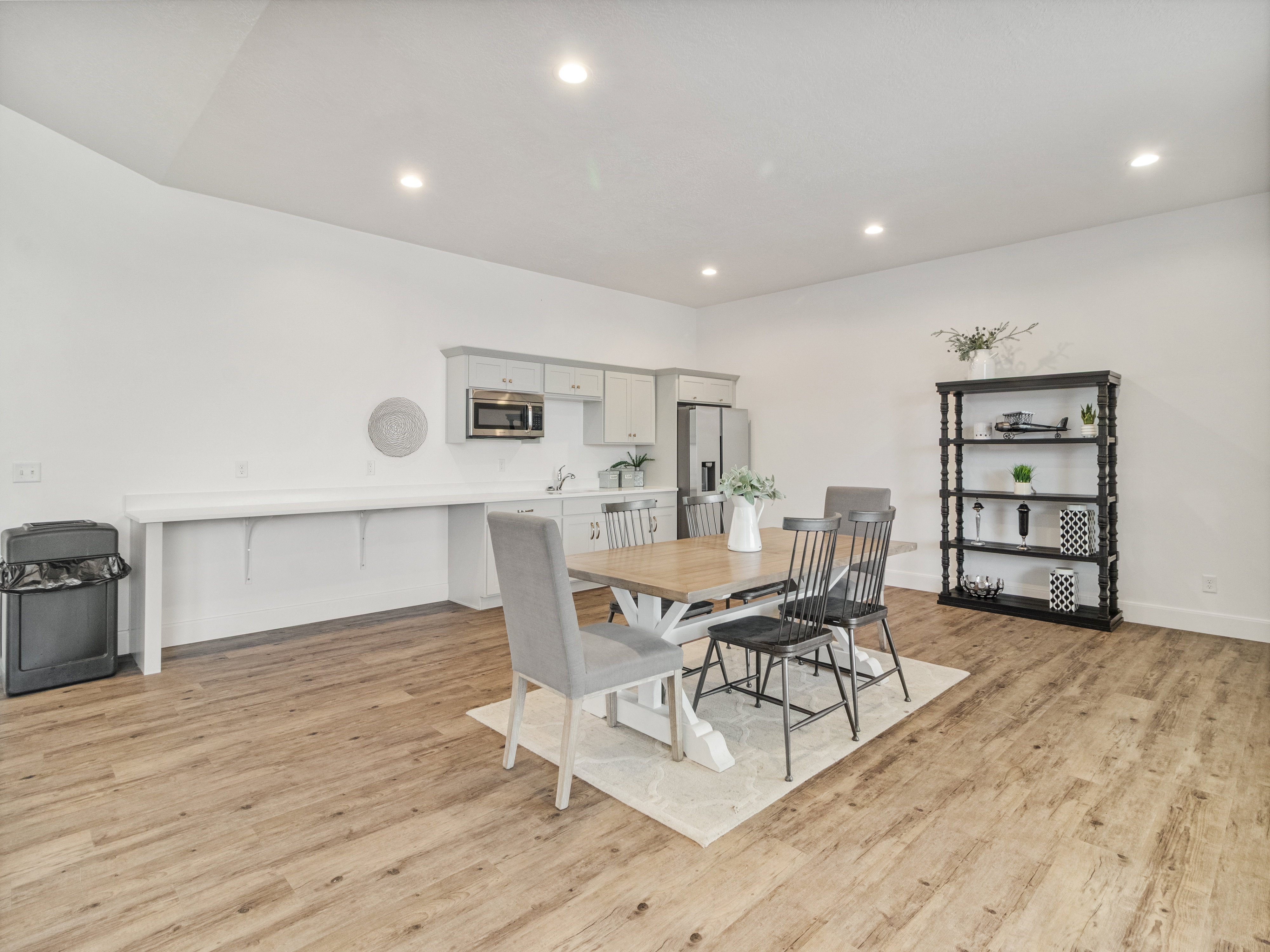 Clubhouse. Spacious room featuring wood-finish flooring, recessed lighting, and a neutral color palette
