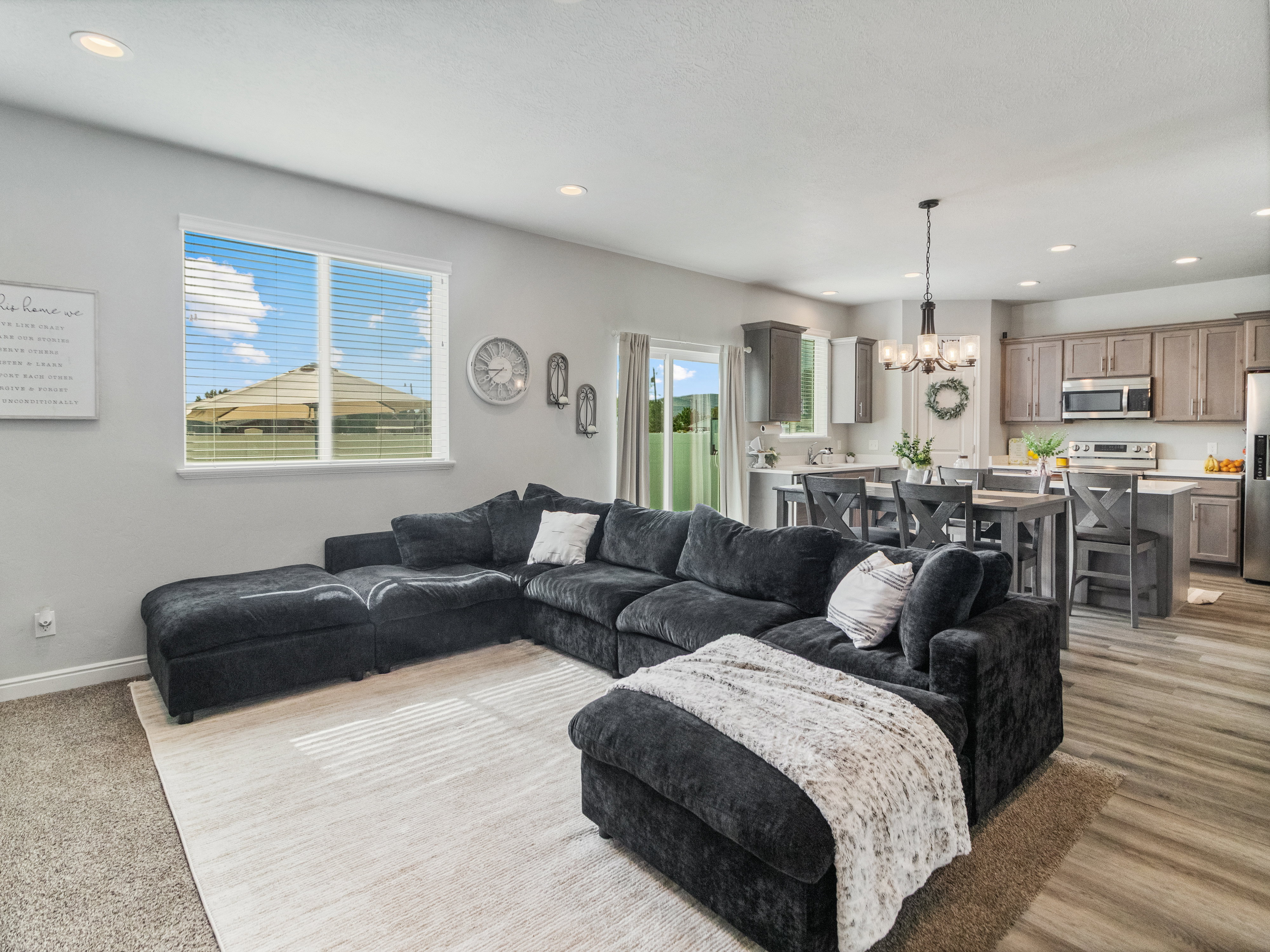 Open-concept living area featuring recessed lighting and a large window