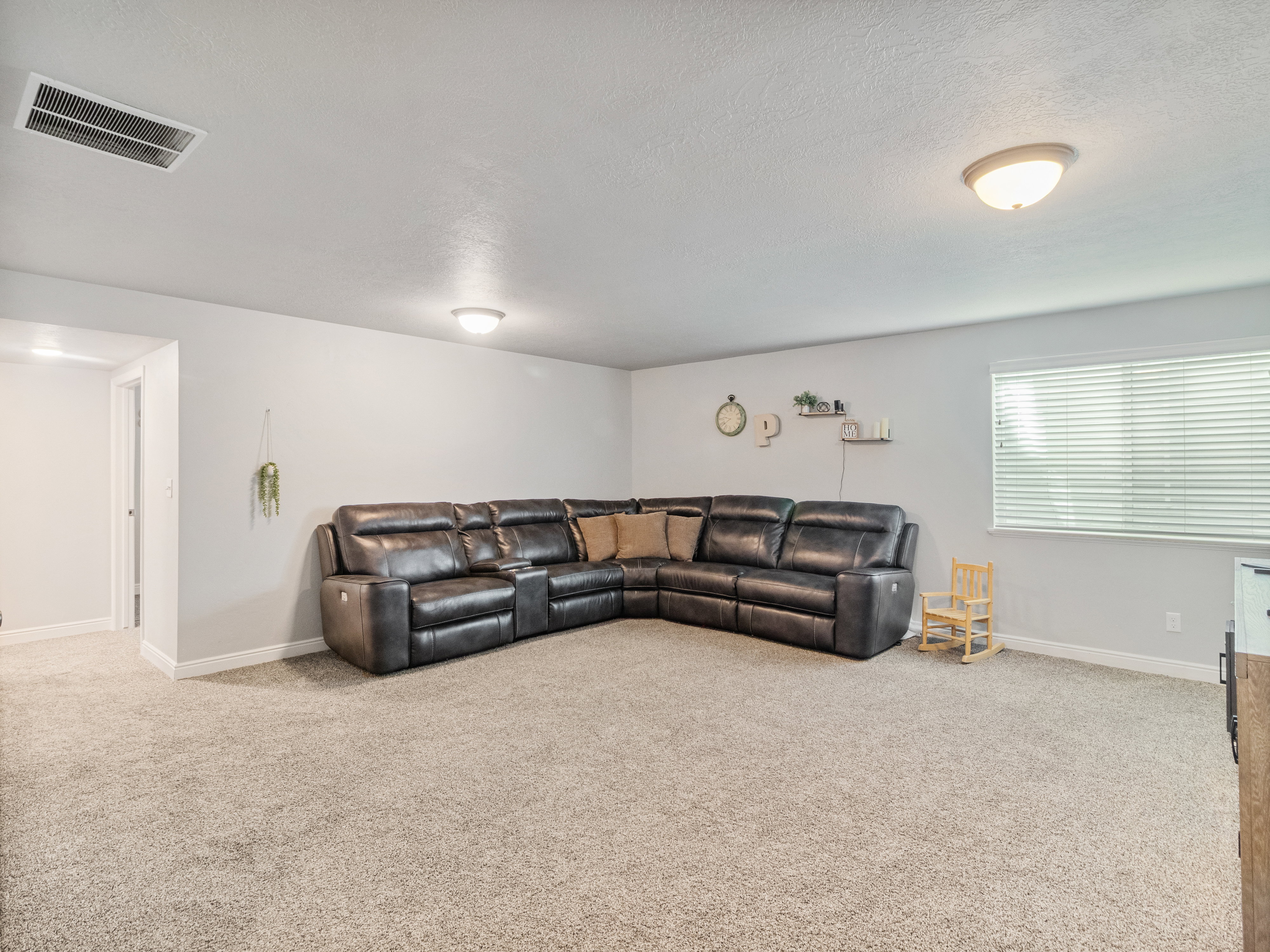 Carpeted floor with light gray walls and white trim