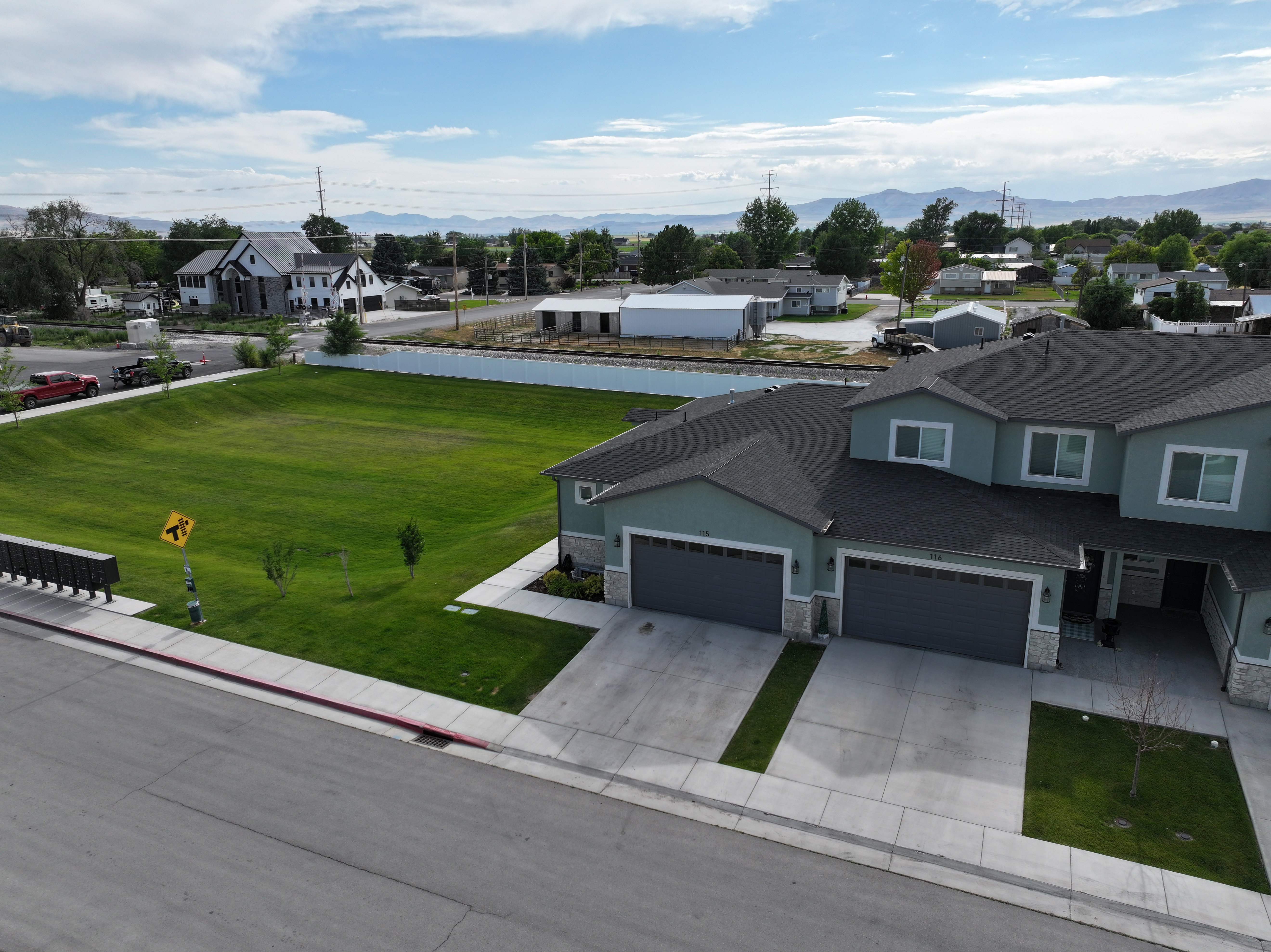 End unit.  Grassy open area and 2 Car Garage.
