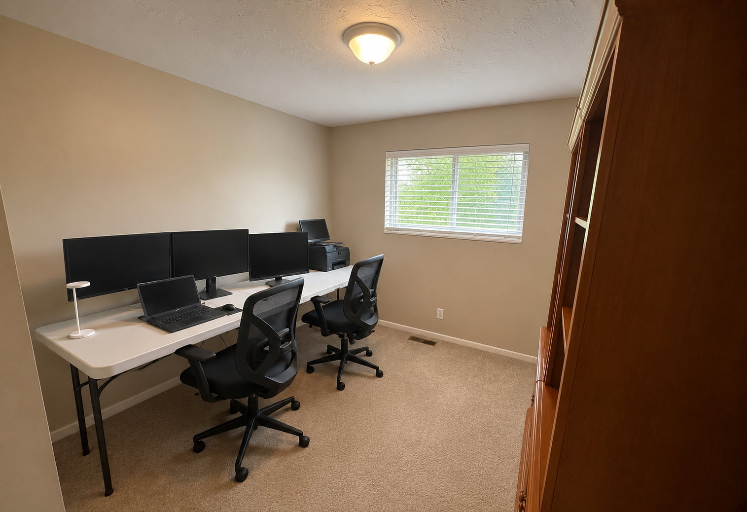 Neutral-toned walls complement the carpet flooring