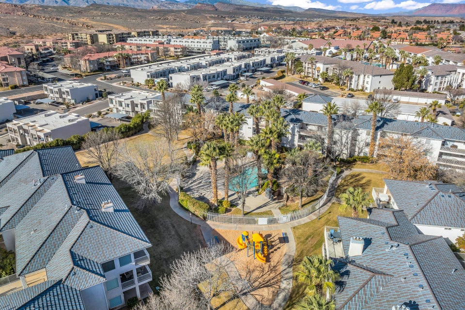 Aerial perspective showcasing the community grounds with a central swimming pool and surrounding paved pathways
