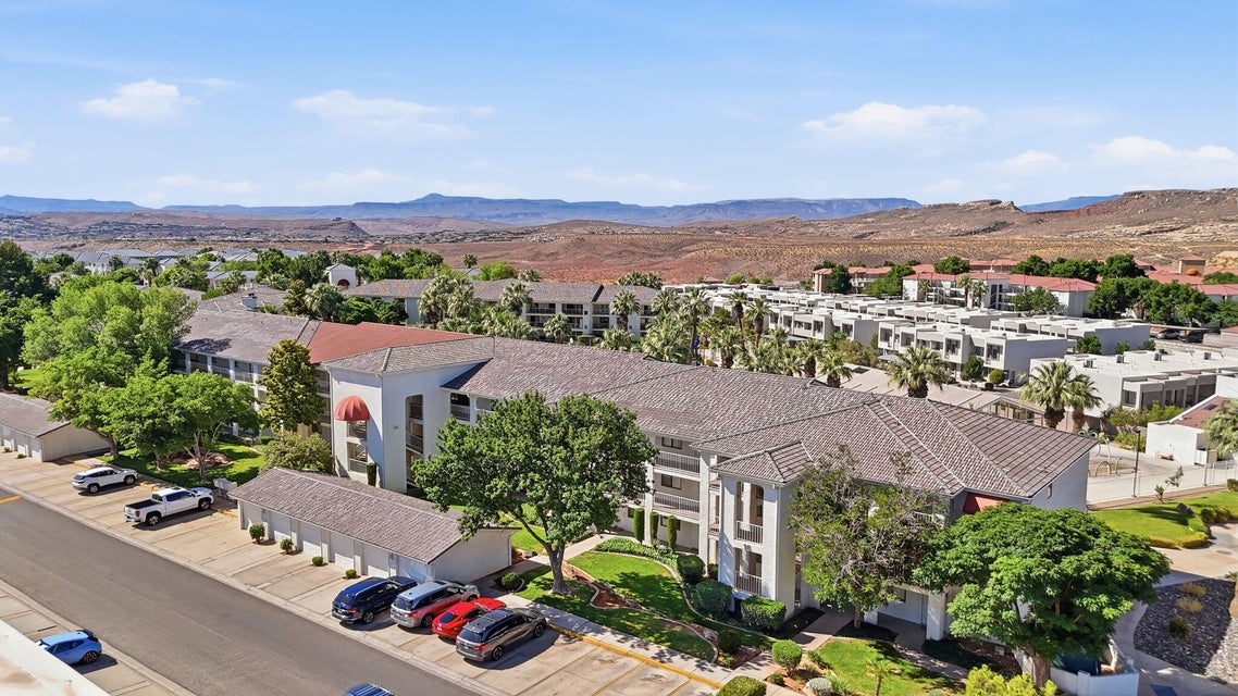 Multi-level residential building with tiled roofing and landscaped grounds