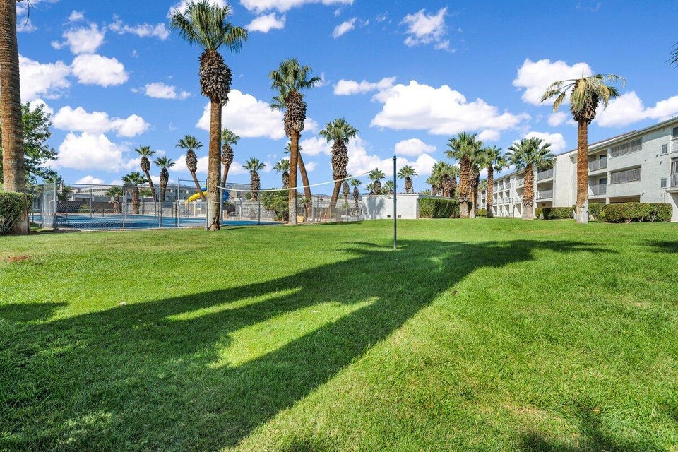Expansive green space featuring a volleyball net
