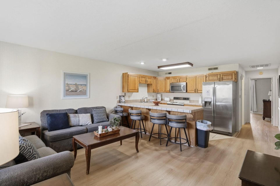 Open-concept living area featuring wood-finish flooring throughout