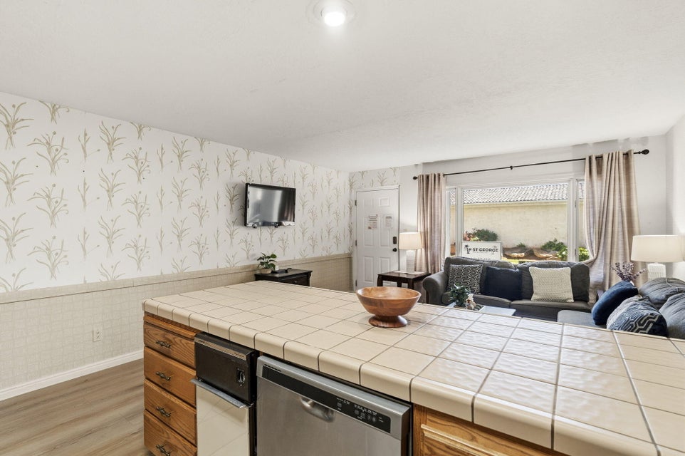 Kitchen island with tile countertop and integrated dishwasher