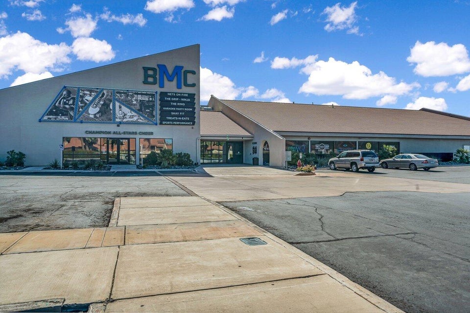 Commercial building featuring a prominent angled facade with large window displays
