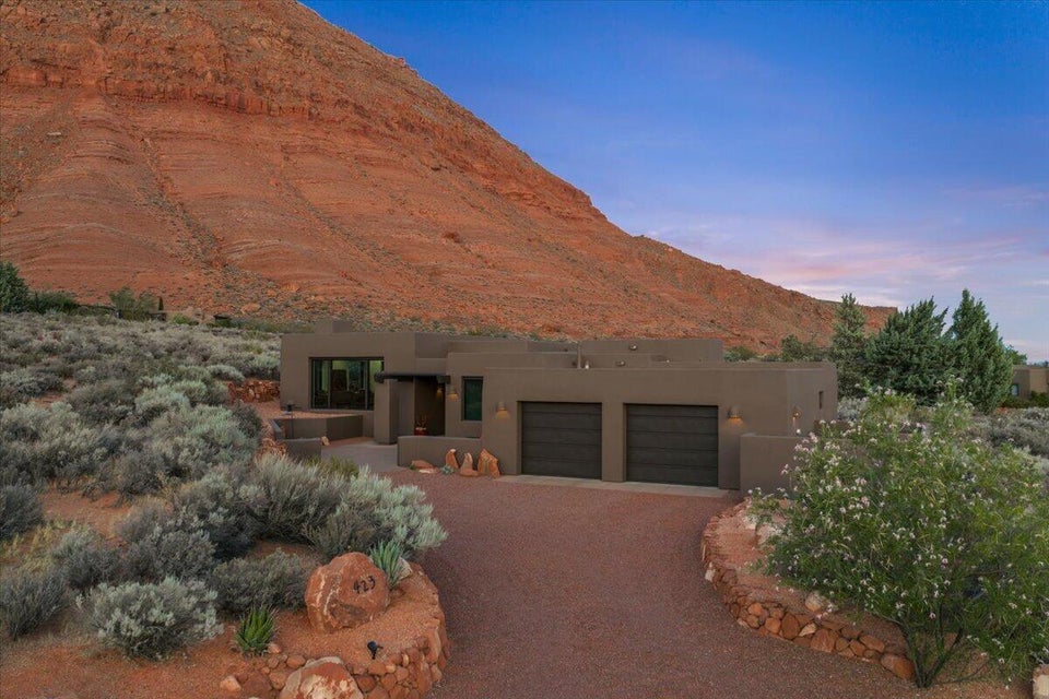Contemporary desert residence featuring a flat roofline and integrated two-car garage