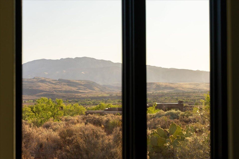 Expansive desert landscape framed by a dark window