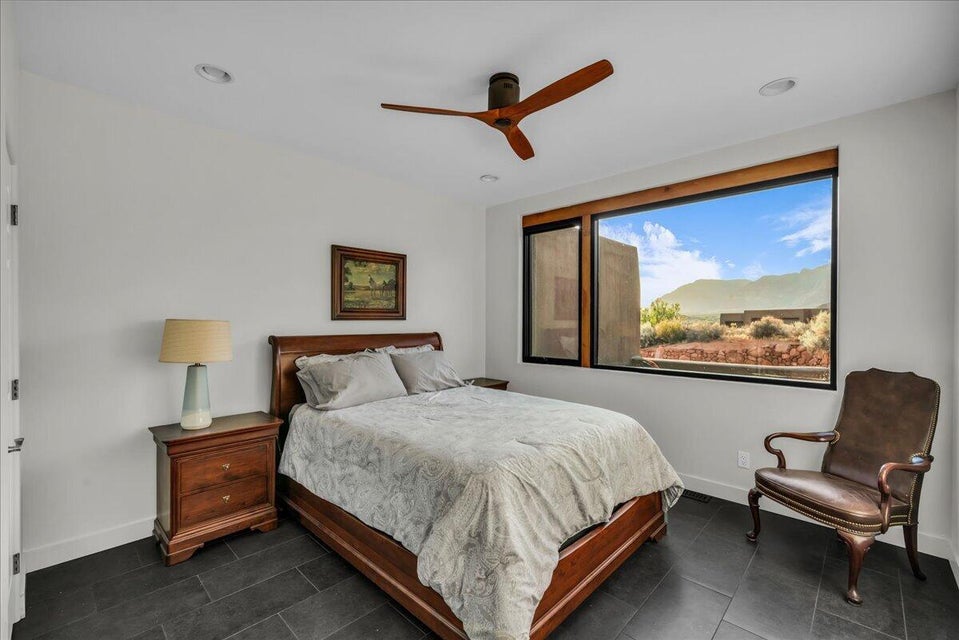 Bedroom featuring a large picture window, dark tile flooring, recessed lighting, and a wood-finish ceiling fan