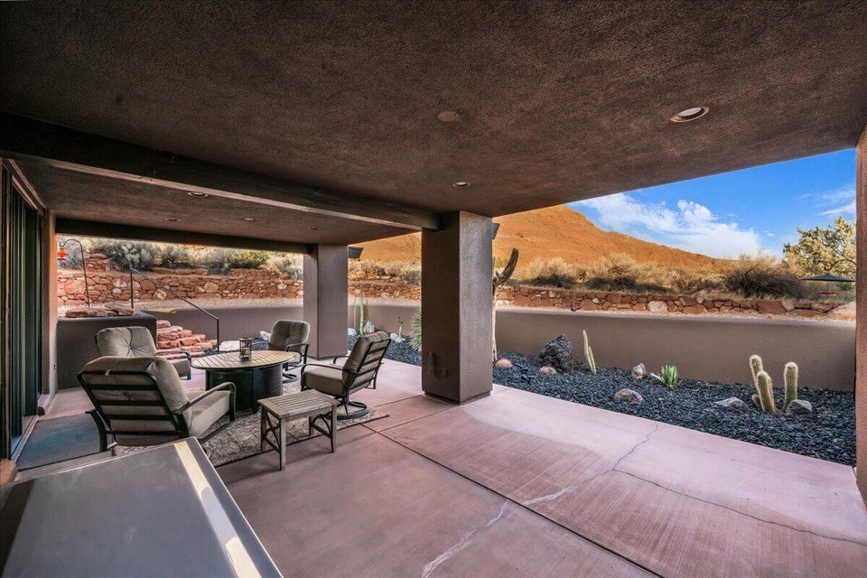 Covered patio with recessed lighting, concrete flooring, and an integrated outdoor cooking station