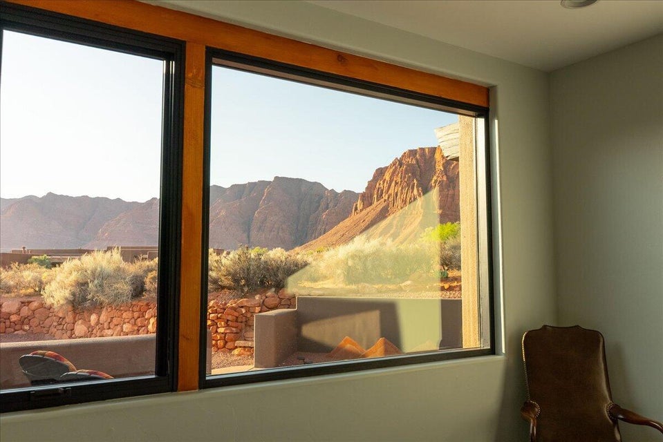 Expansive panoramic window featuring dark frames and natural wood accents
