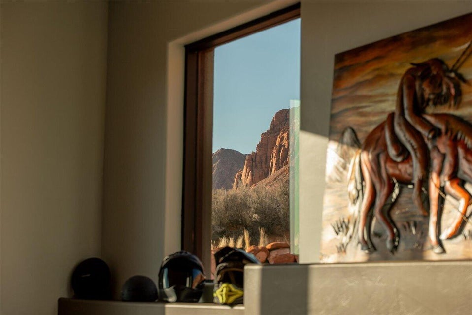 Expansive window framing a mountainous desert landscape